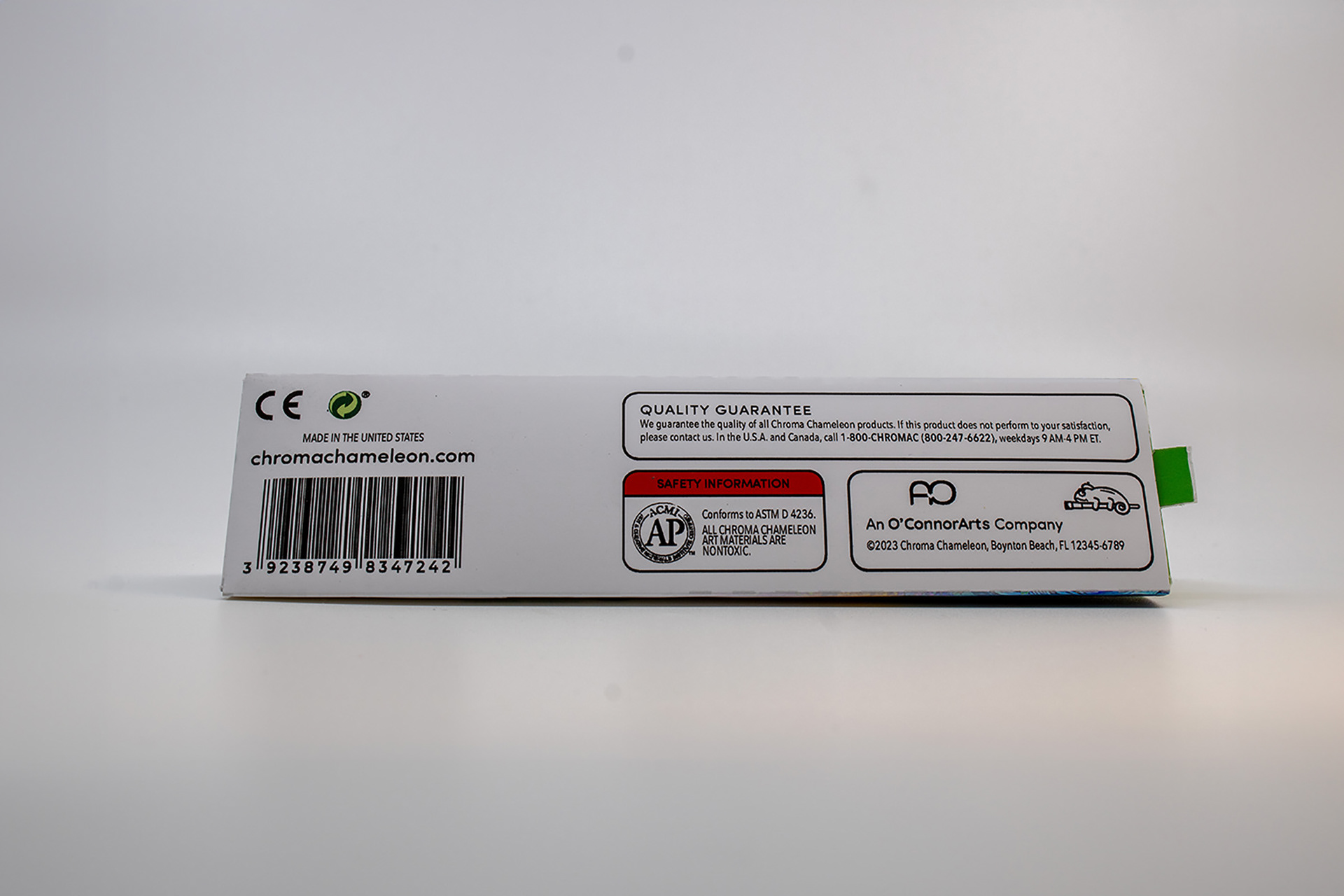Image of the bottom of the Chroma Chameleon package design, featuring manufacturing logos, barcode, brand promise, and warning modals