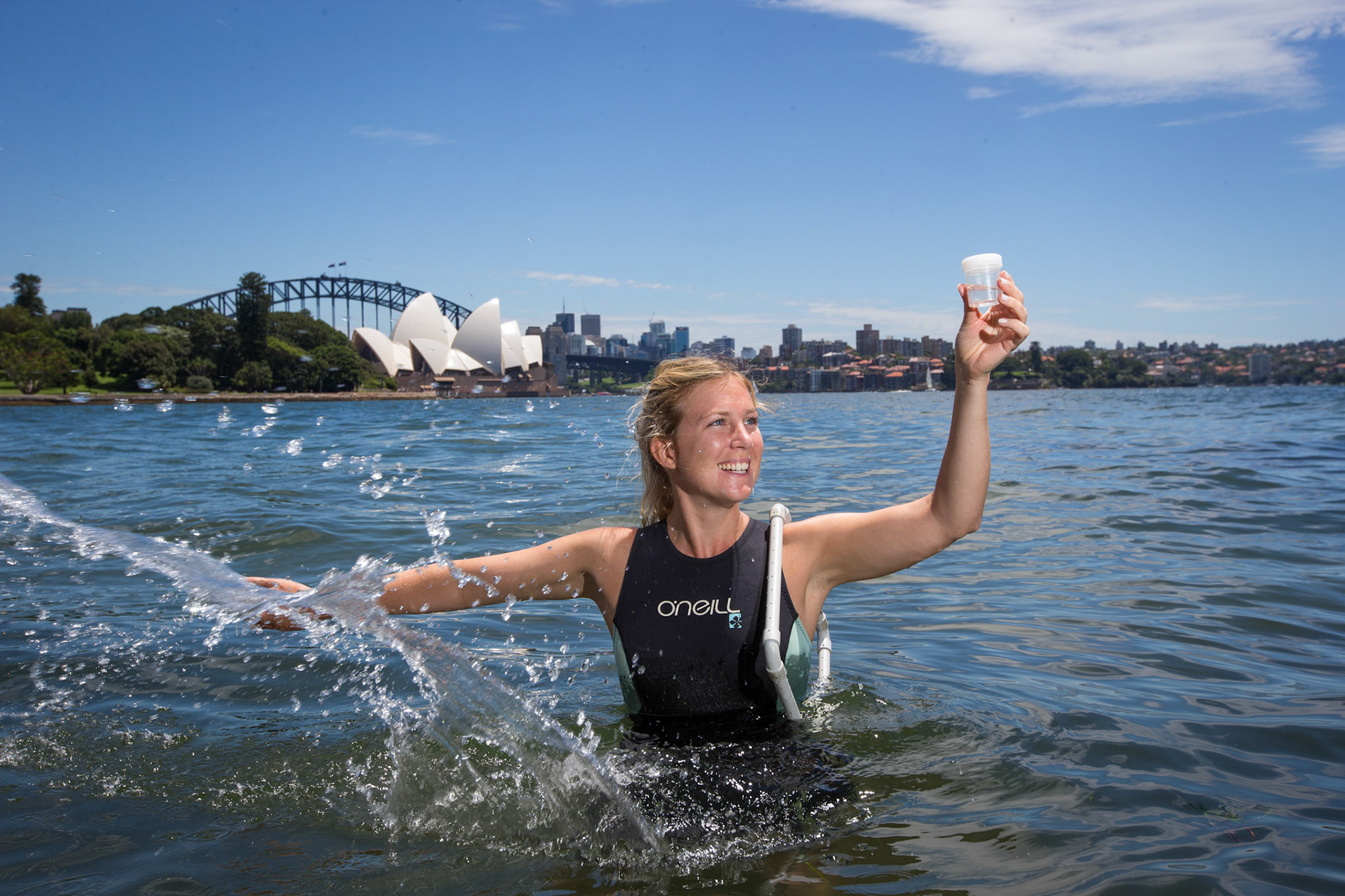 Marine ecologist Rebecca Morris installing new seawall pots along the Sydney Harbour at the Royal Botanic Gardens. 2nd February 2016.