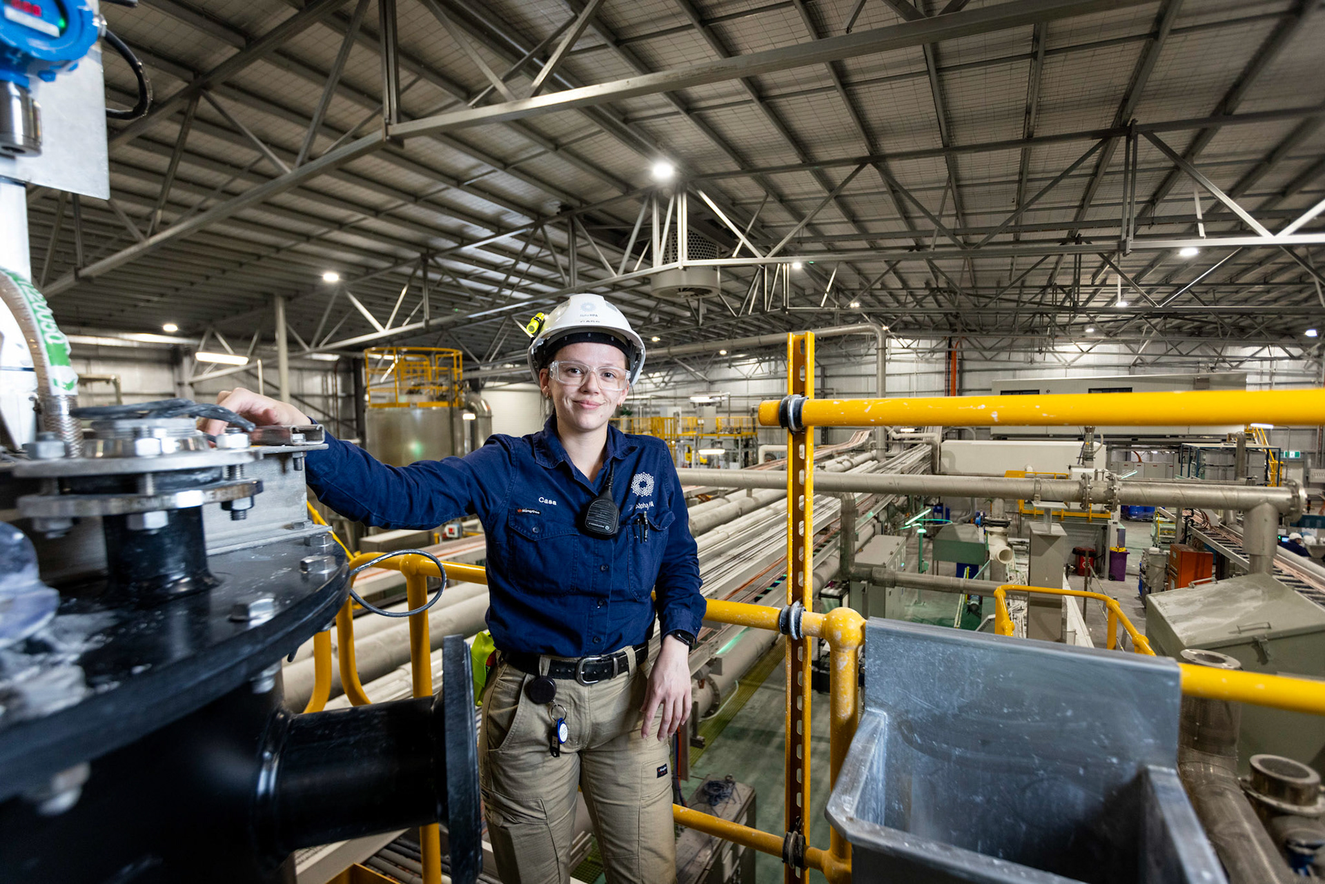 Cassidy Gee Kee, Process Operator at Alpha HPA Gladstone. Cassidy is captured inside the Alpha HPA facility, where cutting-edge technology is shaping the future of high purity alumina production. As a Process Operator, Cassidy’s role within this innovative environment highlights the significance of Central Queensland in advancing clean energy solutions and sustainable manufacturing practices that are critical to Australia’s energy transformation.