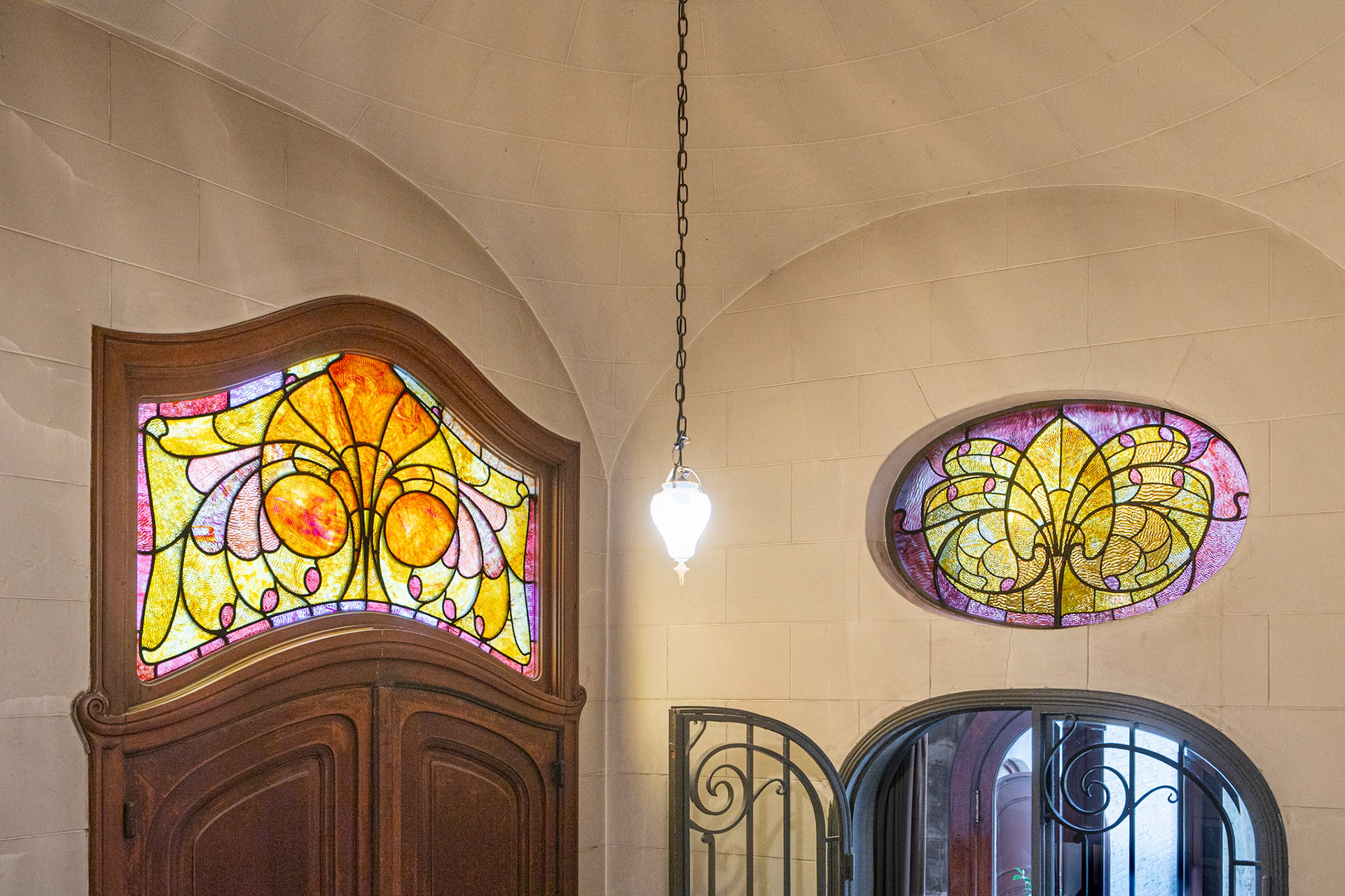 entrance with stained glass windows by Raphaël Évaldre
