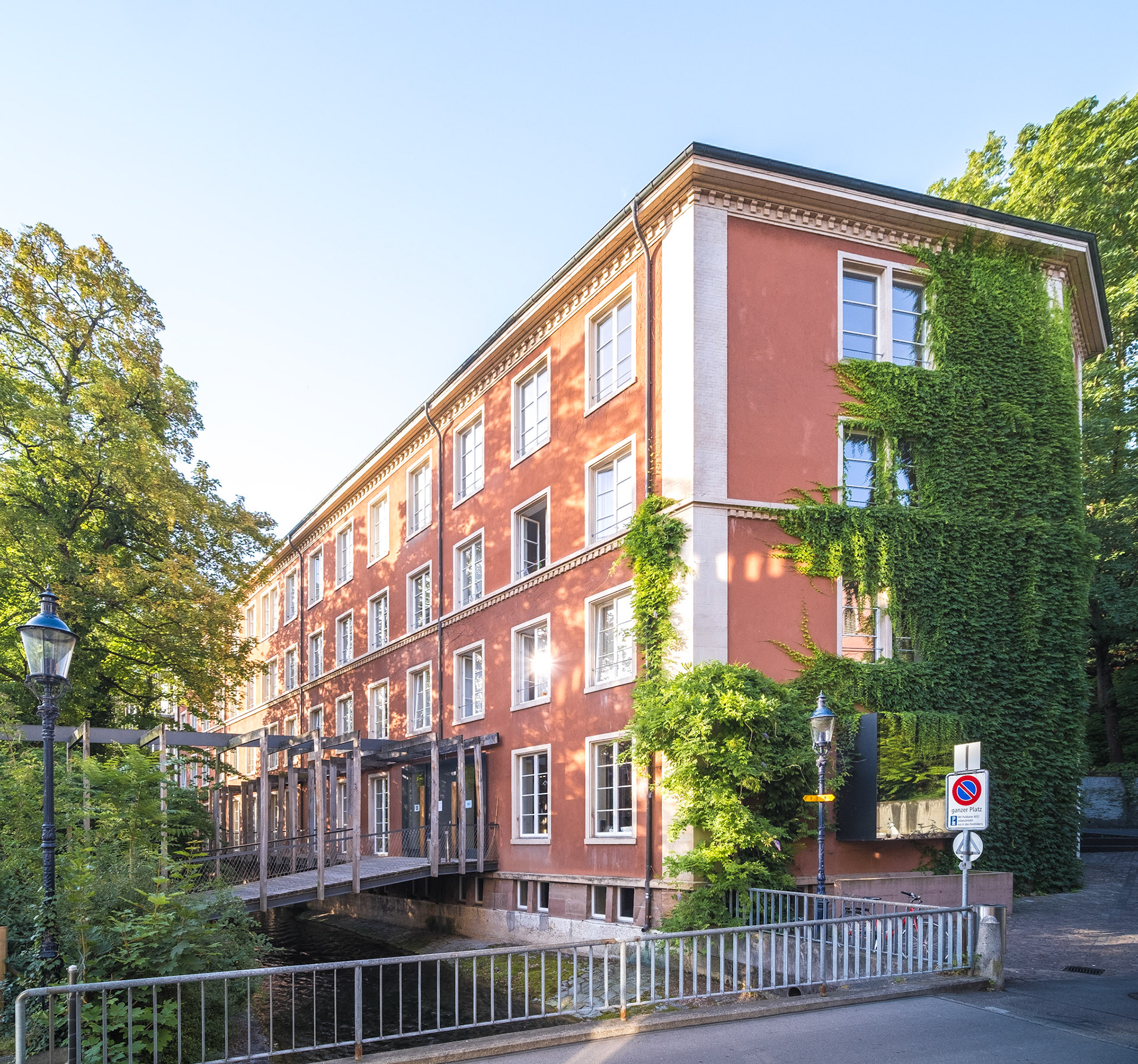 A bridge over the St. Alban pond leads to the Basel Youth Hostel