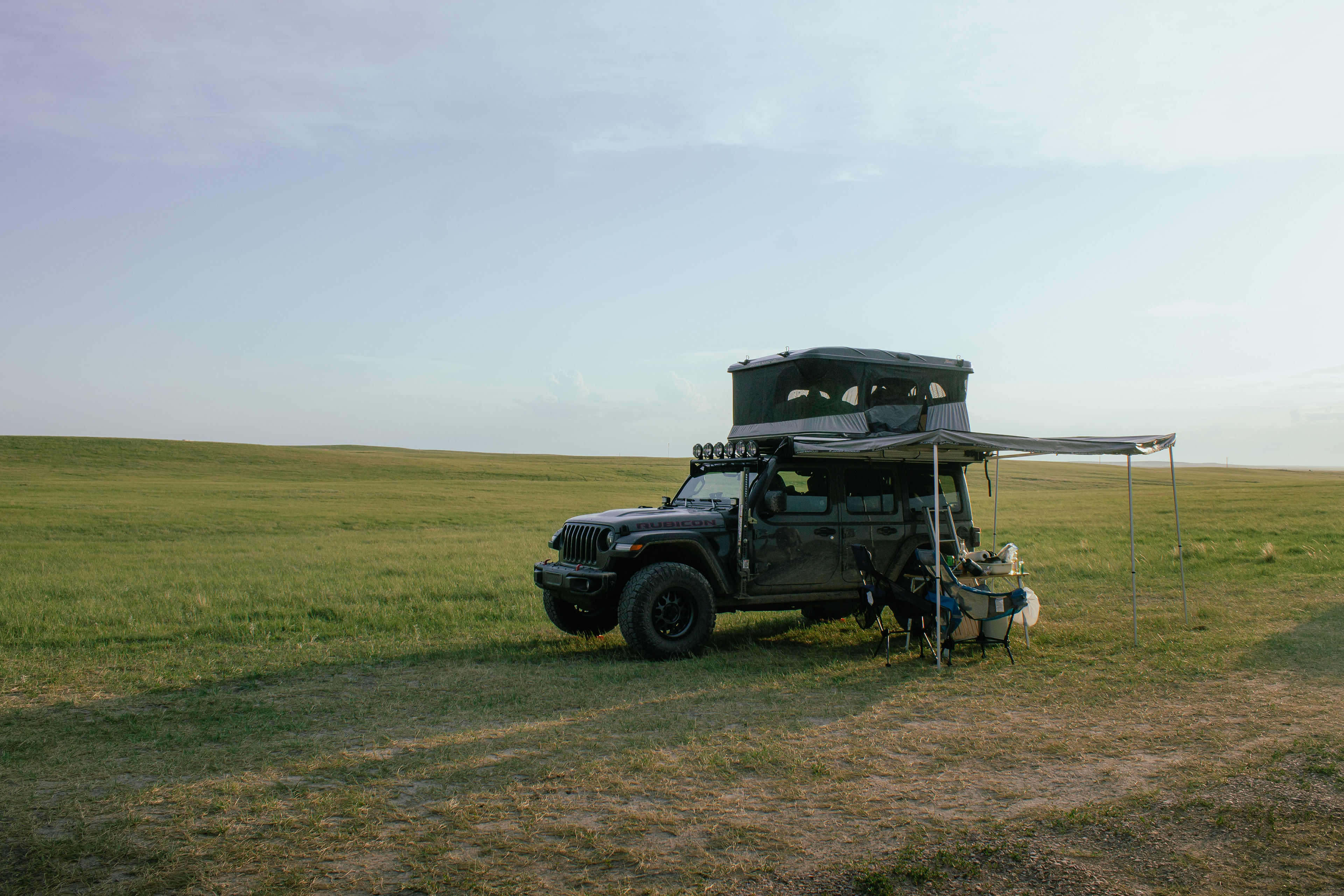 2021 Jeep Wrangler Rubicon with tent, awning, internal storage, light bar, wheels, tires, and suspension setup