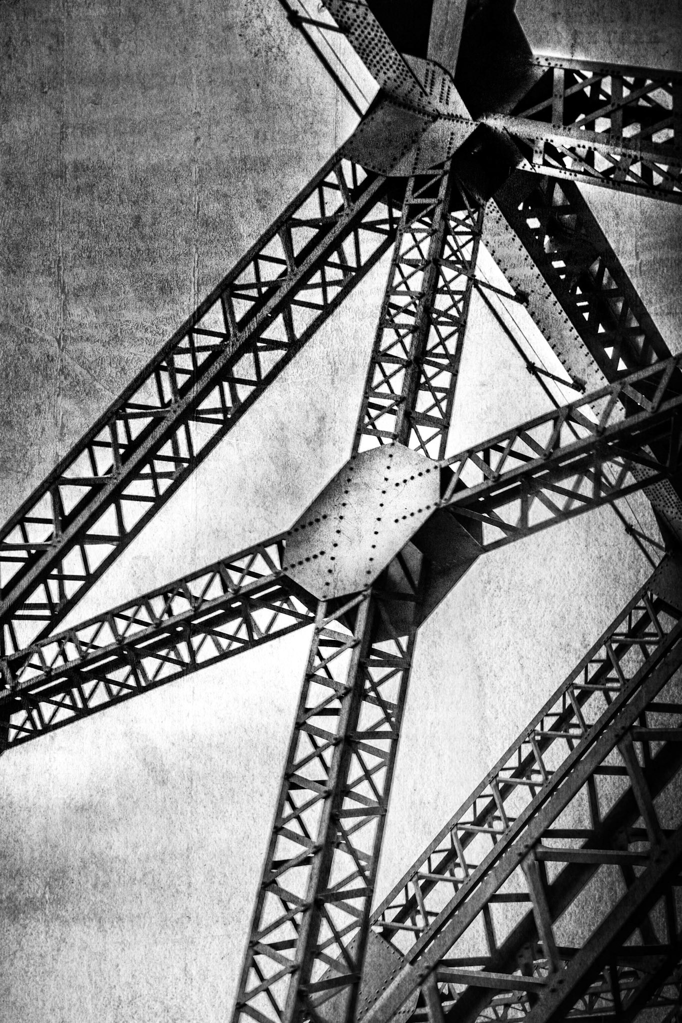 A section of a bridge’s metal framework unfolds in intersecting lines. Function fades in favor of geometry, where strength, repetition, and balance form a silent architecture.  Tags  bridge, structure, industrial architecture, metal, geometry, abstraction, minimalism, mechanical, silence, digital art, fine art photography