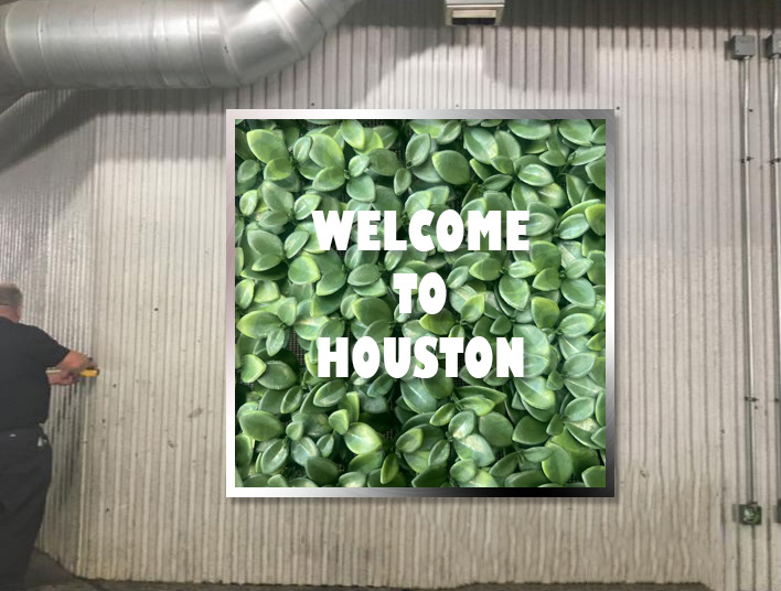 "Welcome to Houston" with stainless steel frame.