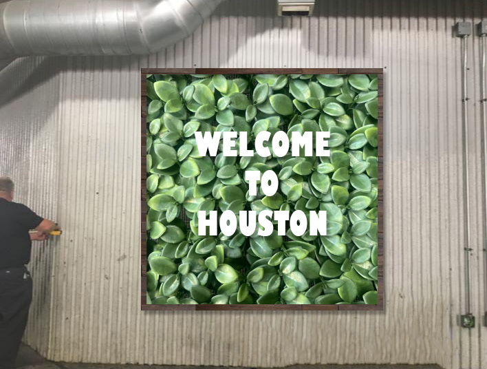 "Welcome to Houston" with rustic wood frame.