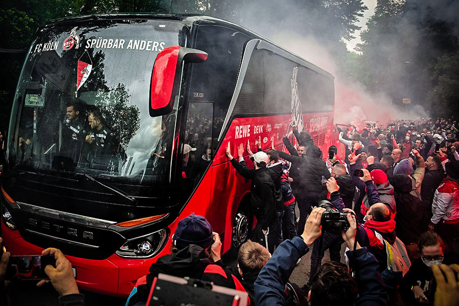 Fans ignite red flares as the Cologne team bus arrives prior to the German Bundesliga soccer match between 1. FC Koeln and FC Schalke 04 in Cologne, Germany, 22 May 2021. (Photo by Sascha Steinbach/epa)