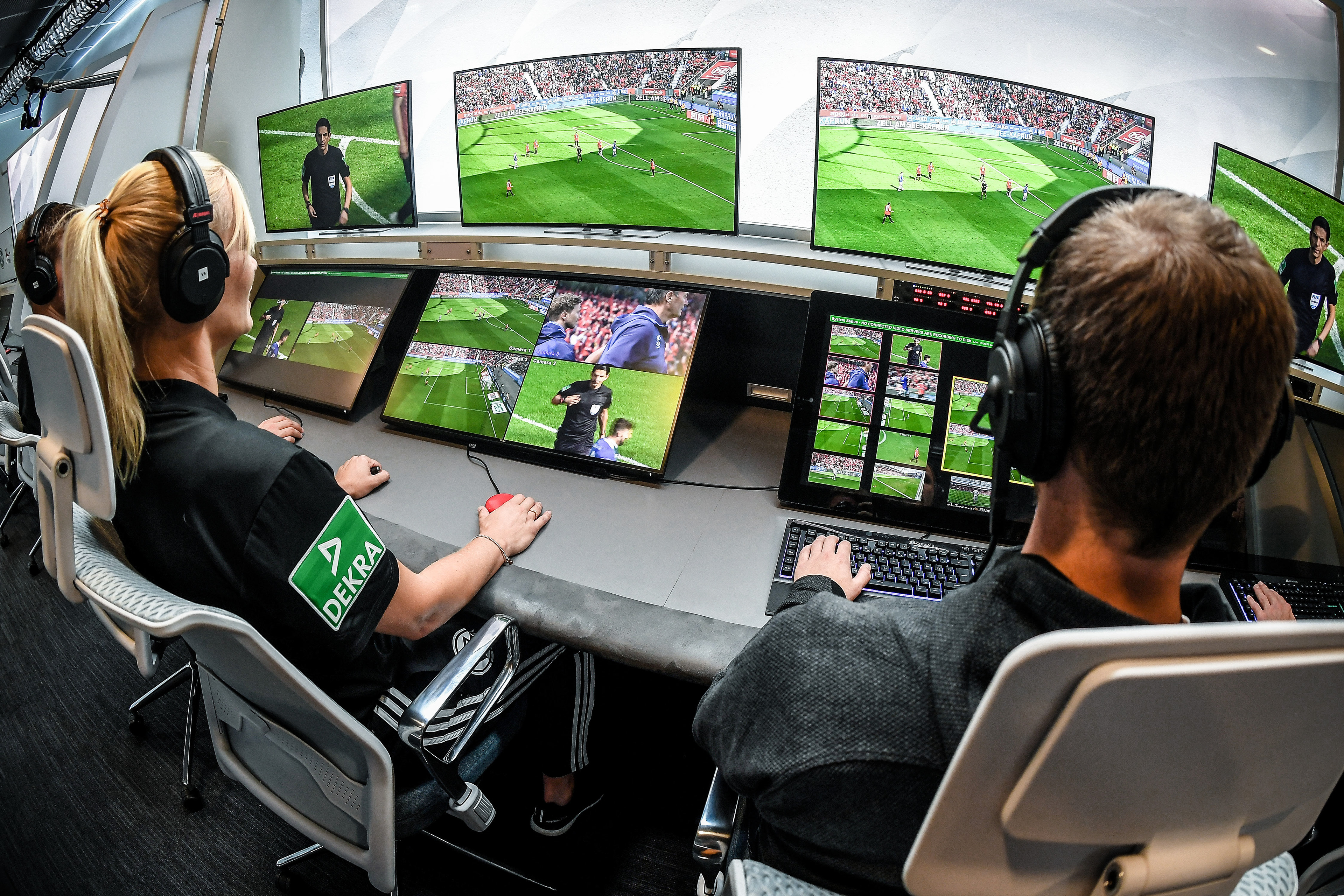 Referee Bibiana Steinhaus (L) and her colleagues sit in front of monitors in the redesigned and expanded Video Assist Center in Cologne, Germany, 05 August 2019. (Photo by Sascha Steinbach/epa)