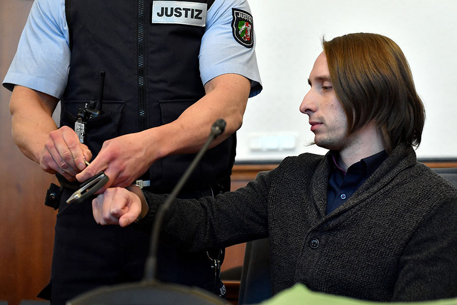 Defendant Sergej W. gets his handcuffs unlocked after arriving at the district court in Dortmund, Germany, 19 March 2018. The 28-year-old defendant is charged with attempted murder for detonating three homemade bombs next to the Borussia Dortmund team bus and their entourage when they travelled to a UEFA Champions League match against Monaco at the Dortmund Westfalen stadium on 11 April 2017. (Photo by Sascha Steinbach/epa)