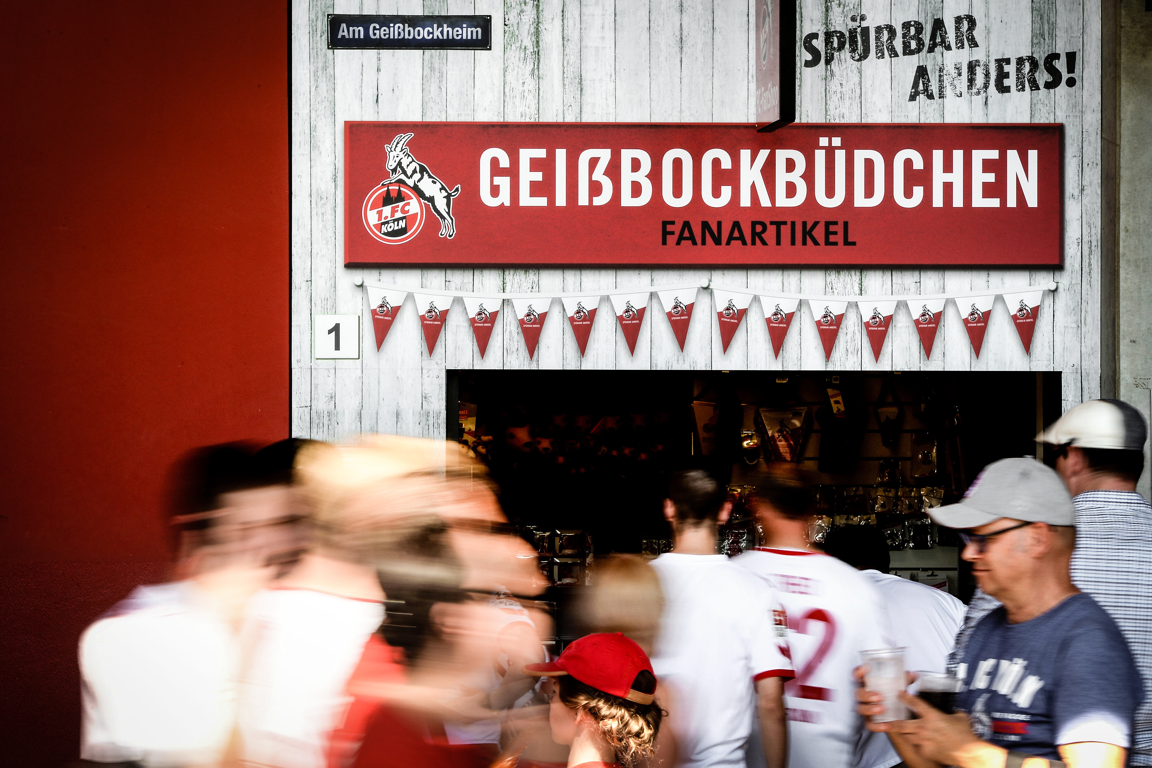 Supporters walk past a fan booth during the Bundesliga match between 1. FC Koeln and SV Darmstadt 98 at RheinEnergieStadion on August 27, 2016 in Cologne, Germany.  (Photo by Sascha Steinbach/Getty Images For 1. FC Koeln)