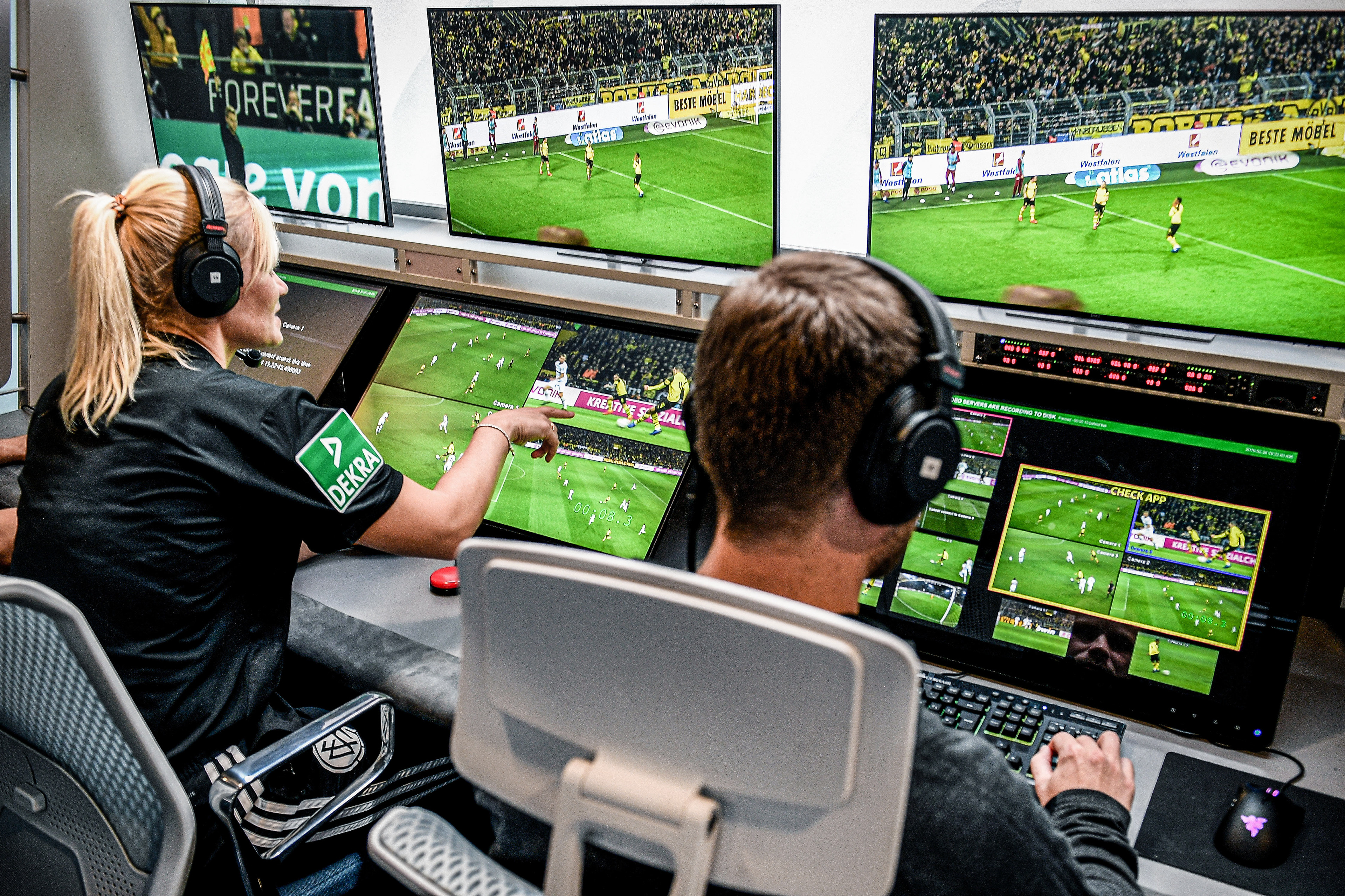 Referee Bibiana Steinhaus (L) and her colleagues sit in front of monitors in the redesigned and expanded Video Assist Center in Cologne, Germany, 05 August 2019. (Photo by Sascha Steinbach/epa)