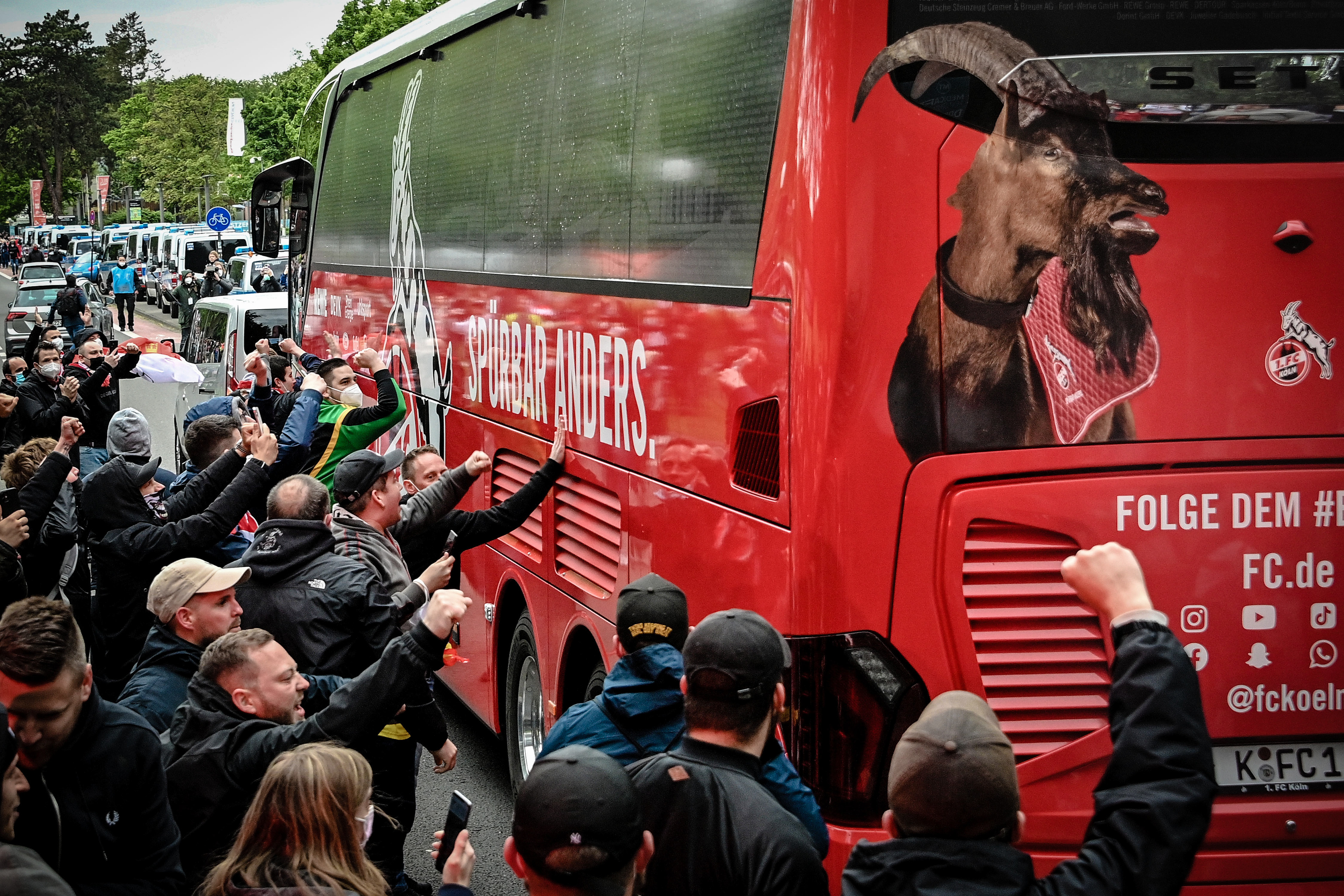 Fans clap against the arriving Cologne team bus prior to the German Bundesliga soccer match between 1. FC Koeln and FC Schalke 04 in Cologne, Germany, 22 May 2021. (Photo by Sascha Steinbach/epa)