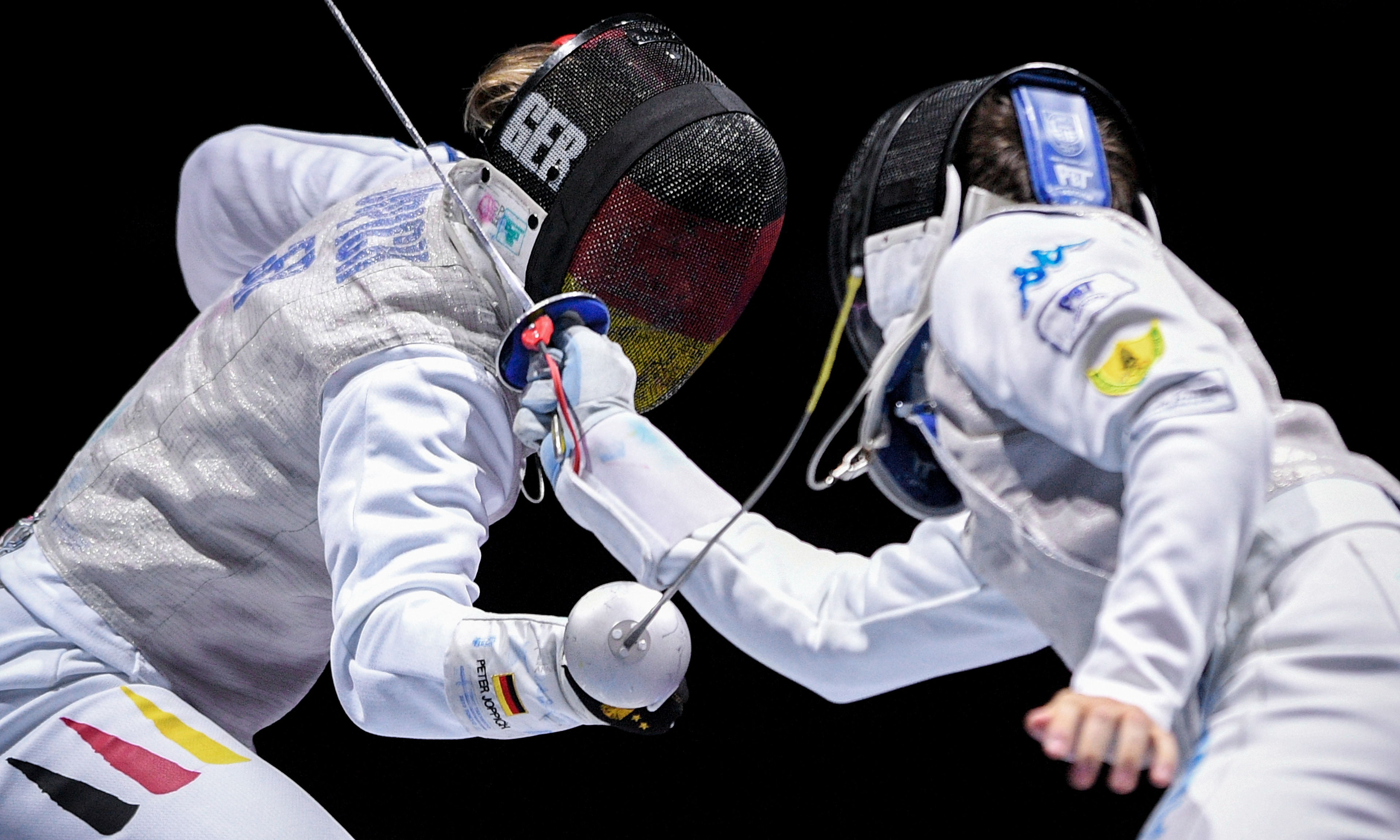 Peter Joppich of Germany (L) in action against Daniele Garozzo (R) during the foil men's team semi final of the 2019 Fencing European Championships in Duesseldorf, Germany, 20 June 2019. (Photo by Sascha Steinbach/epa)