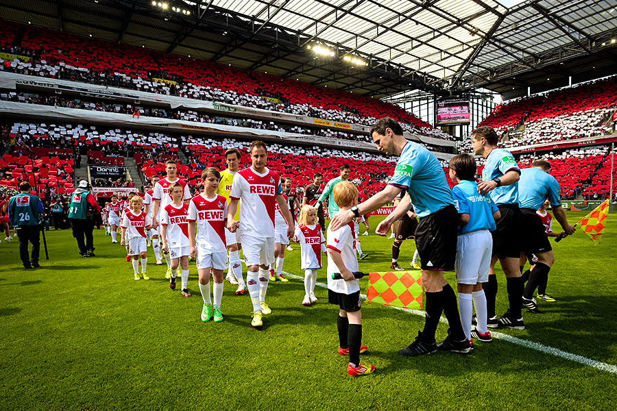 Referees and teams enter the pitch at the start of the 2nd Bundesliga match between 1. FC Koeln and FC St. Pauli at RheinEnergieStadion in Cologne, Germany, 04 May 2014.  (Photo by Sascha Steinbach/Getty Images for DFL)