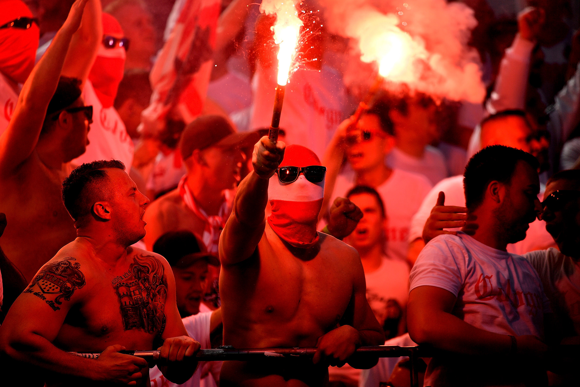 Cologne supporters ignite red flares during the German Bundesliga soccer match between Bayer 04 Leverkusen and 1. FC Cologne in Leverkusen, Germany, 13 May 2017. (Photo by Sascha Steinbach/epa)
