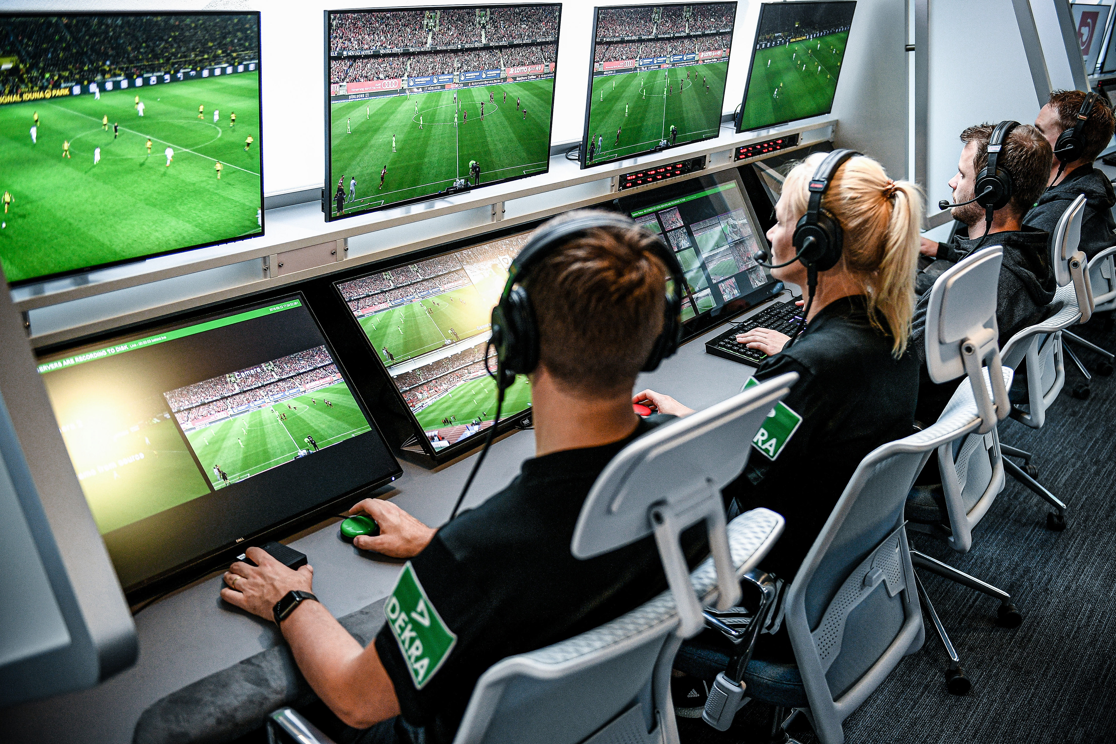 Referee Bibiana Steinhaus (3-R) and her colleagues sit in front of monitors in the redesigned and expanded Video Assist Center in Cologne, Germany, 05 August 2019. (Photo by Sascha Steinbach/epa)