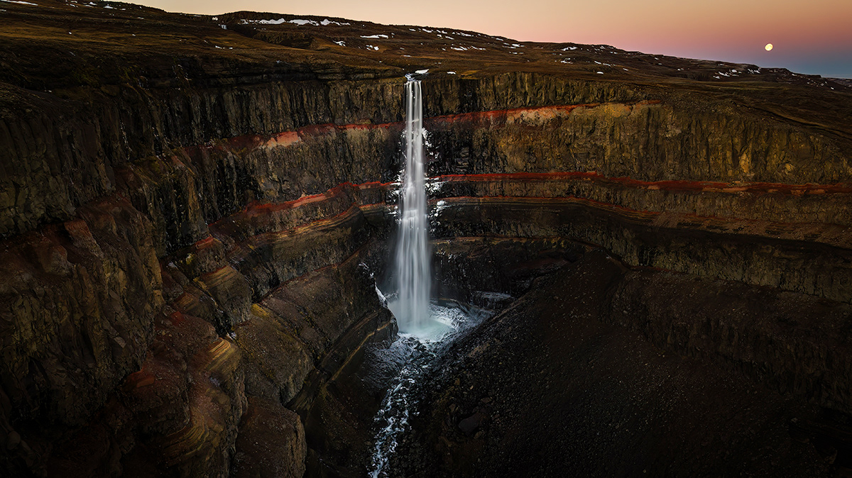 Waterfall Hengifoss and the moon