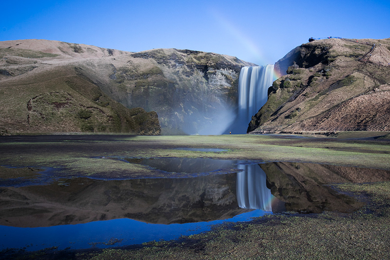 Skógafoss and its reflection