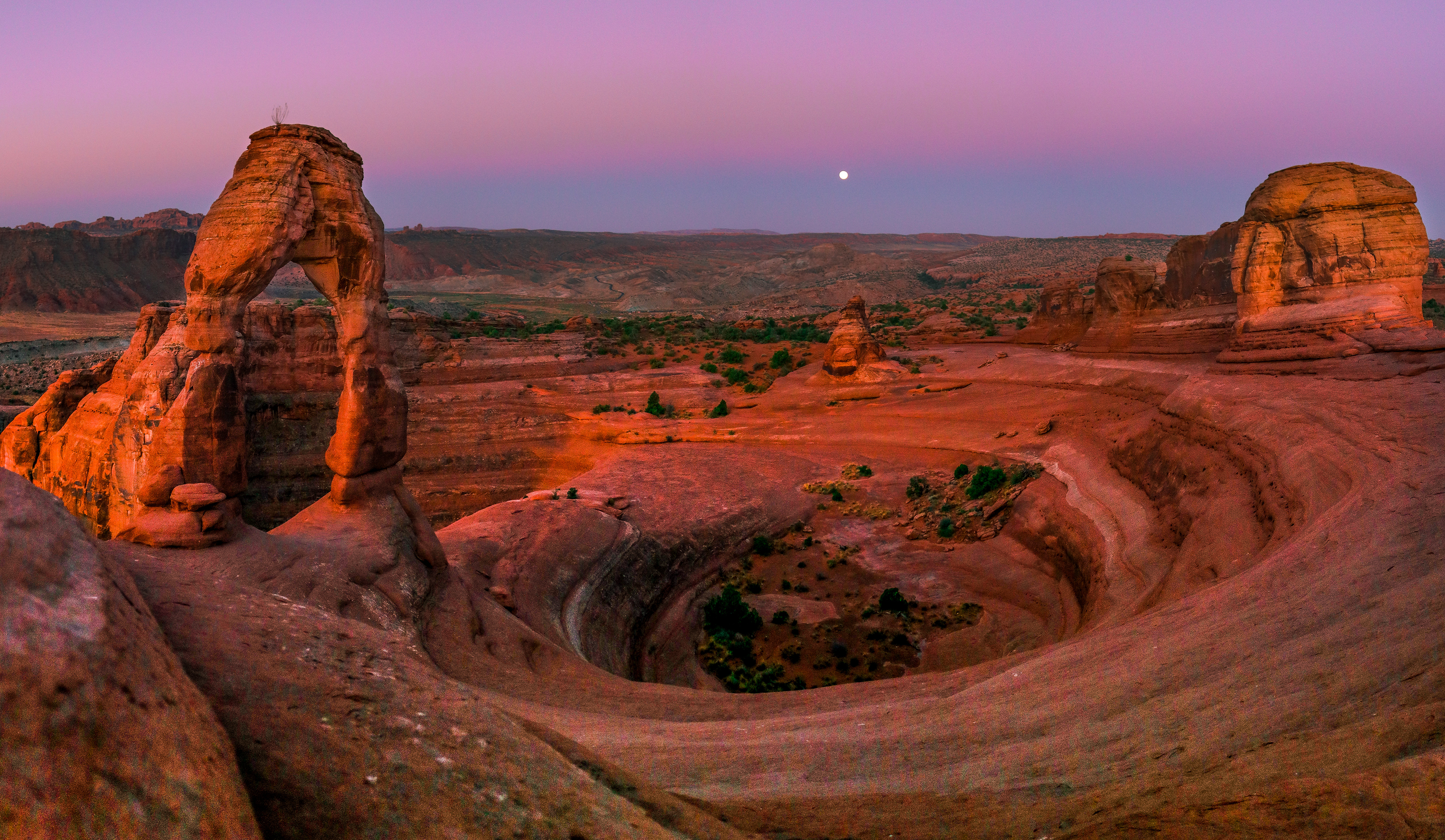 Arches National Park, Utah.  [ Sun rising in the background as Friday the 13th Full Moon sets from the night]