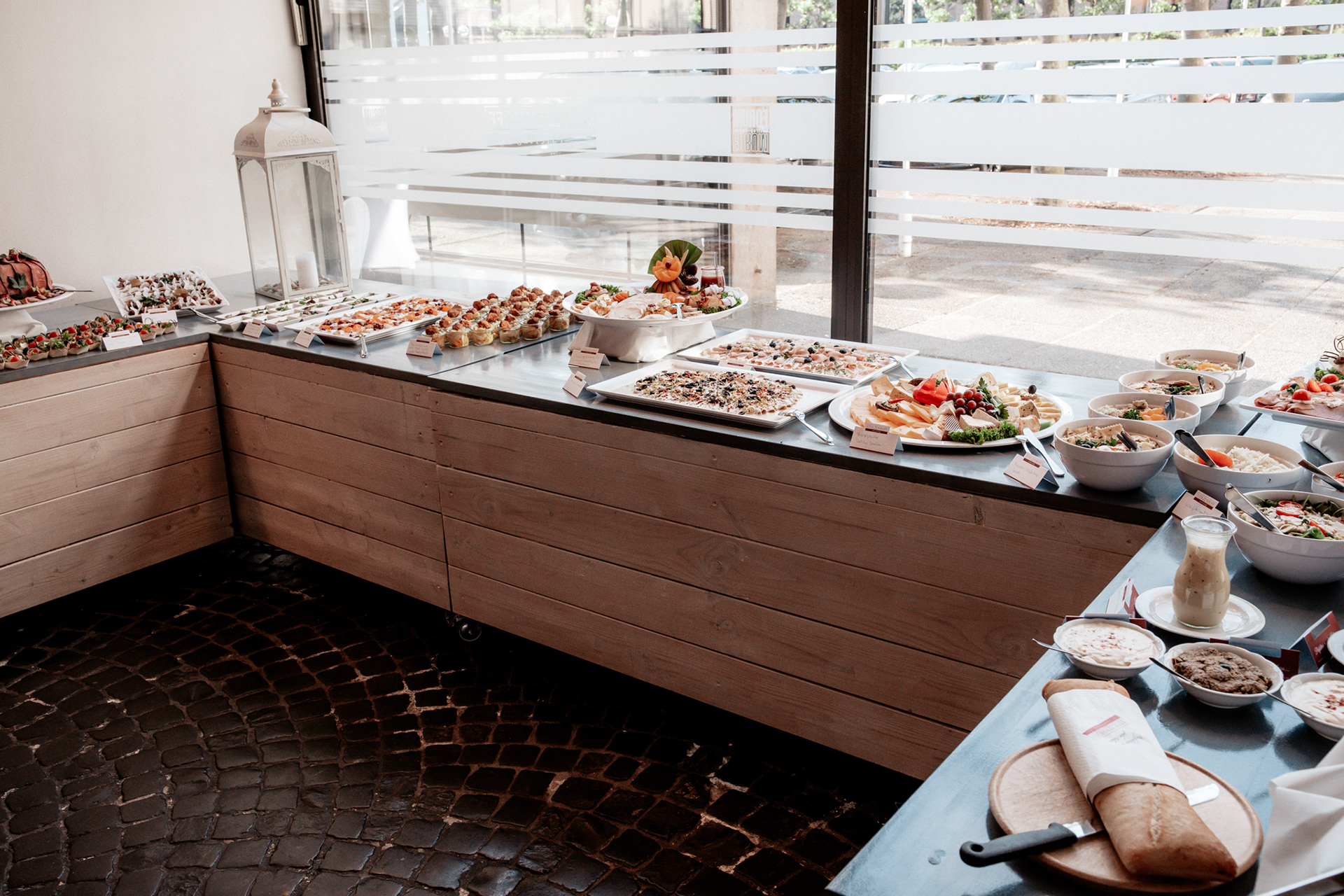 Umfangreiches Hochzeitsbuffet in der Feierlocation in Dortmund. Von herzhaften Speisen bis zu kreativen Fingerfood-Kreationen – die festliche Hochzeitsgesellschaft genießt eine exquisite Auswahl an kulinarischen Köstlichkeiten in stilvoller Atmosphäre.