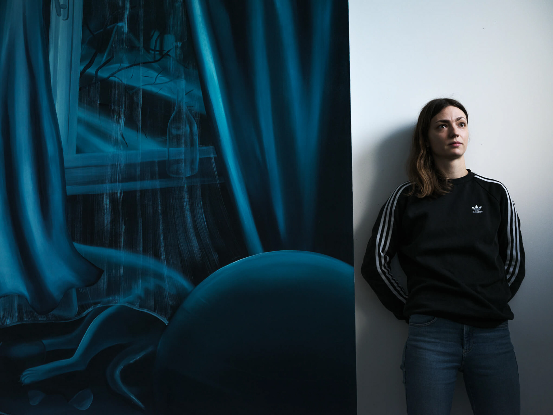 Karolina Jabłońska w pracowni z obrazem "Patrzenie przez okno"