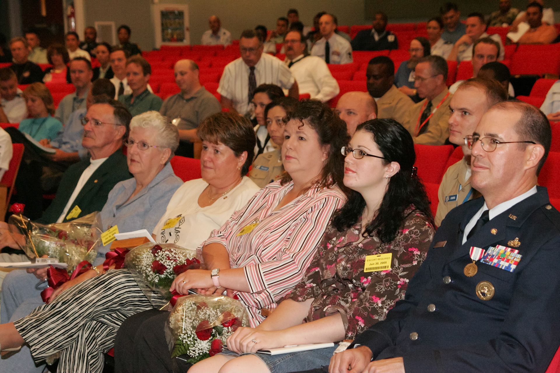 Family watching slideshow presentation at retirement ceremony - Pentagon, Washington, DC