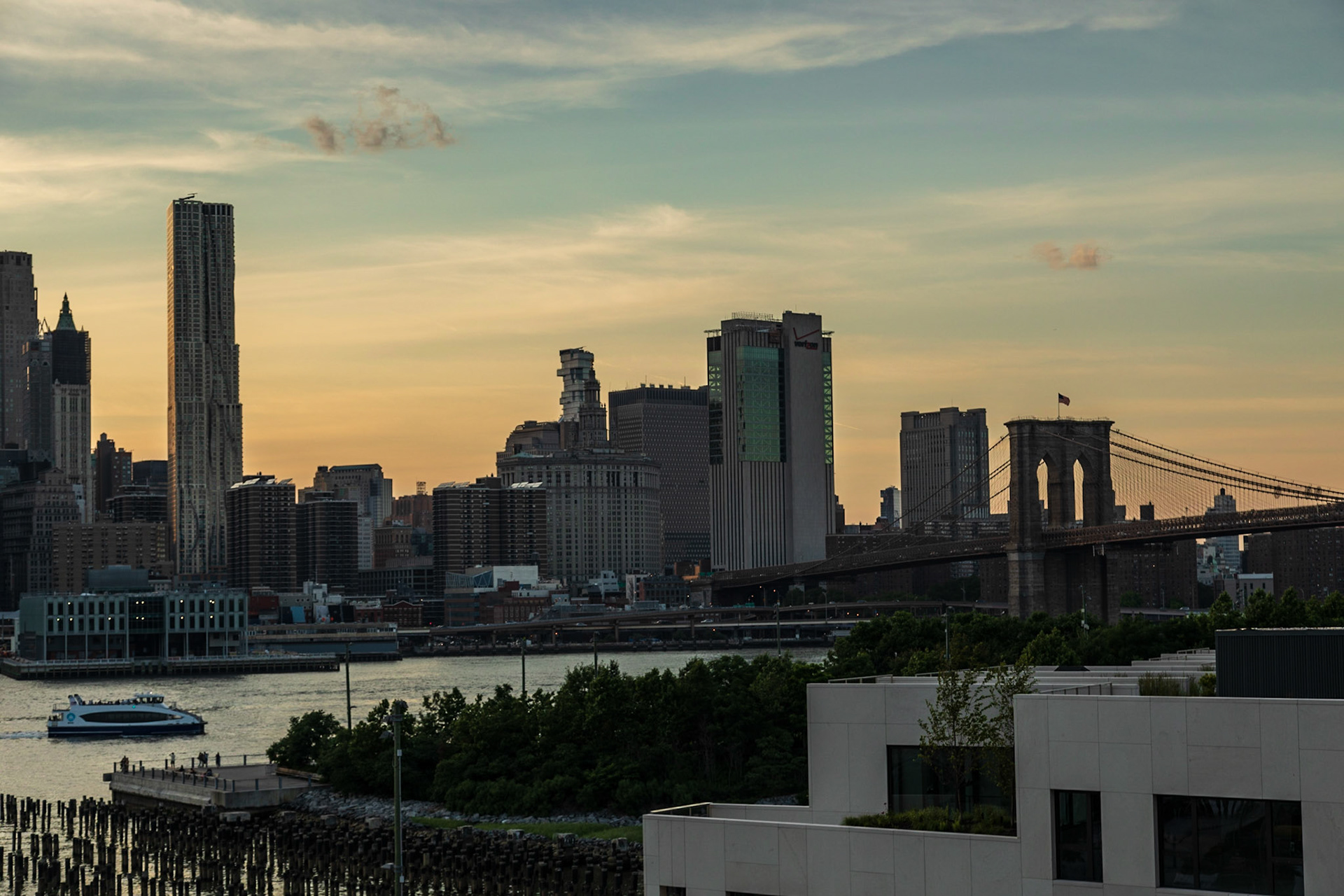 Manhatten Skyline with Brooklyn Bridge at sunset - New York, New York City