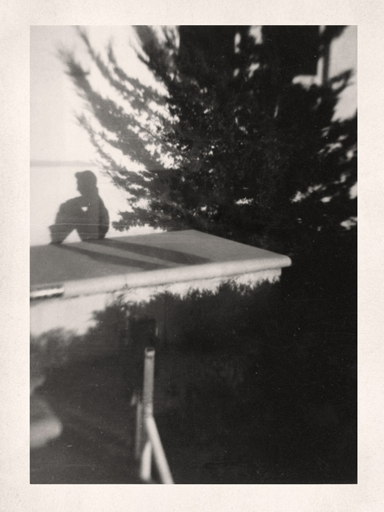 Traces: Boy Sitting by Wall. Greg Sand.