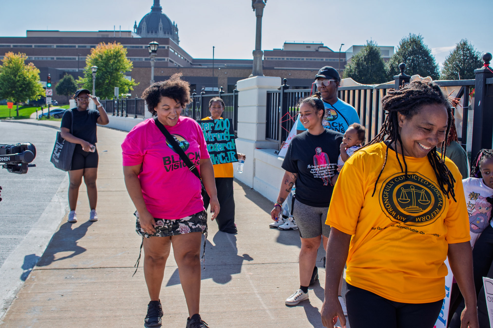 Julia Johnson, Carmen Hernandez, Marvina Haynes, and other activists are seen at the banner drop for Wrongful Incarceration Day in St. Paul, MN. 10/2/2025