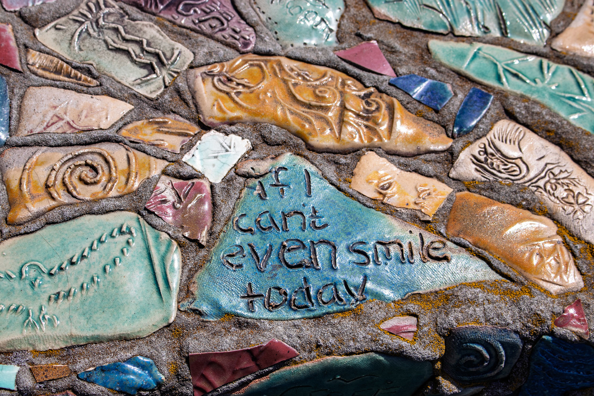 Tiles on benches that are part of a sculpture made by people incarcerated in MCF Shakopee between 1994 - 1995. Displayed at Franconia Sculpture Park.