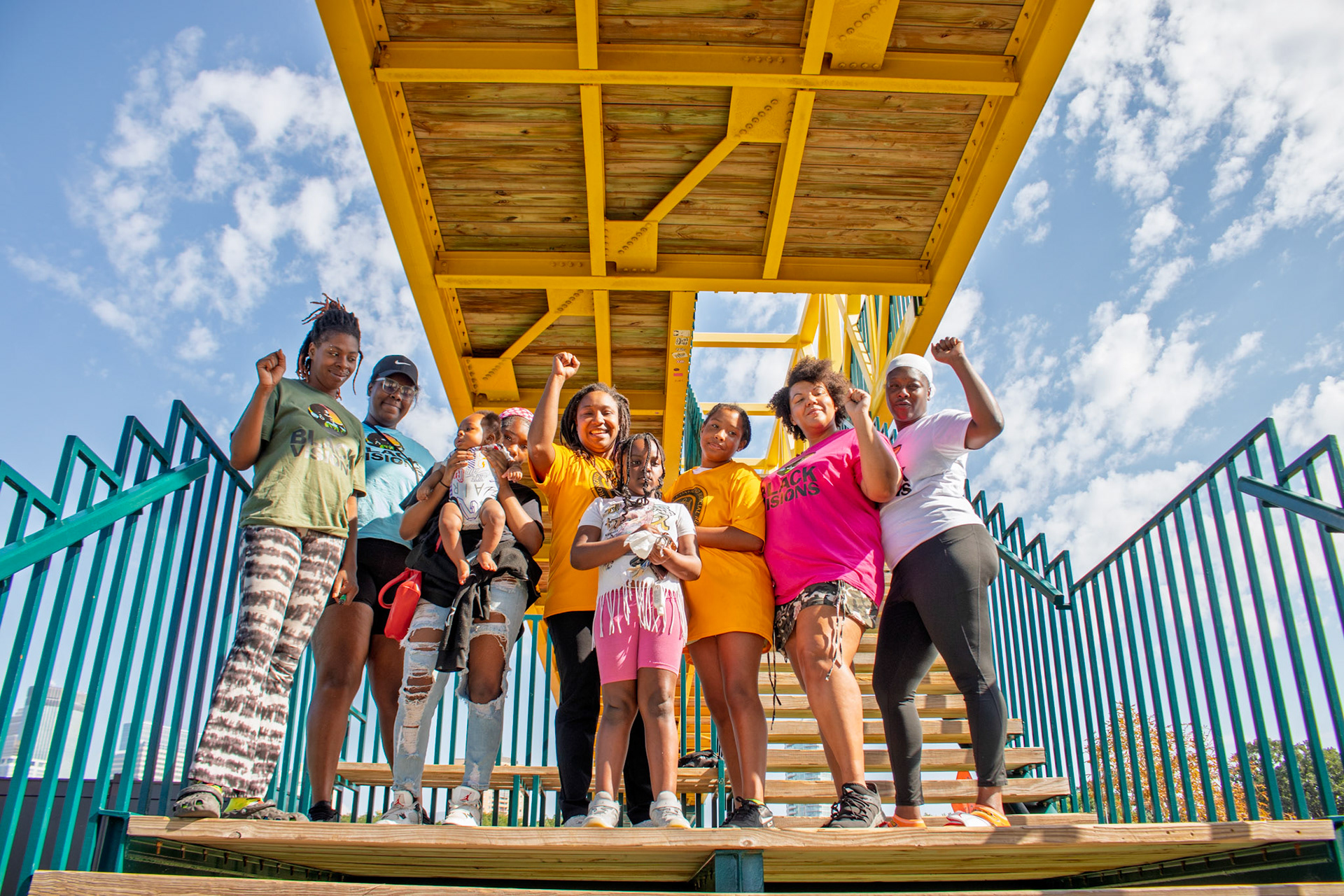A group of activists after dropping a banner over the Irene Hixon Whitney Bridge near the Minneapolis Sculpture Garden on 10/2/2025.