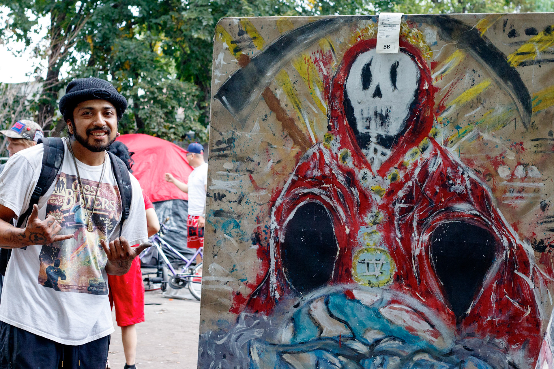 "Texas" and his art painted on discarded furniture / wood he finds near the encampment where he resides.