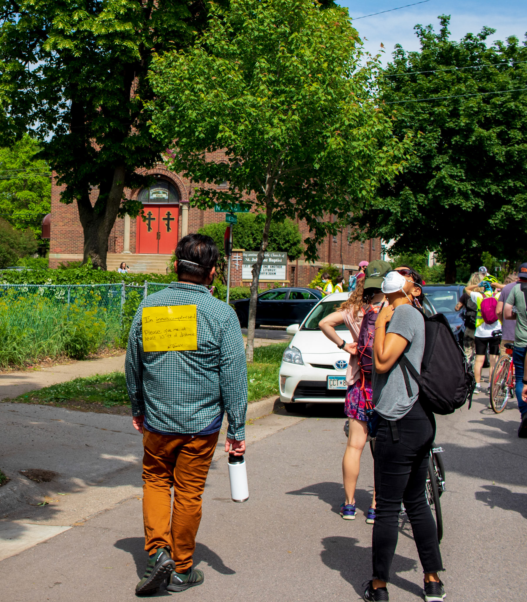 An Immuncompromised person attended the June 6, 2020 protests in Minneapolis. The other person is eyeing the loud helicopter circling above.