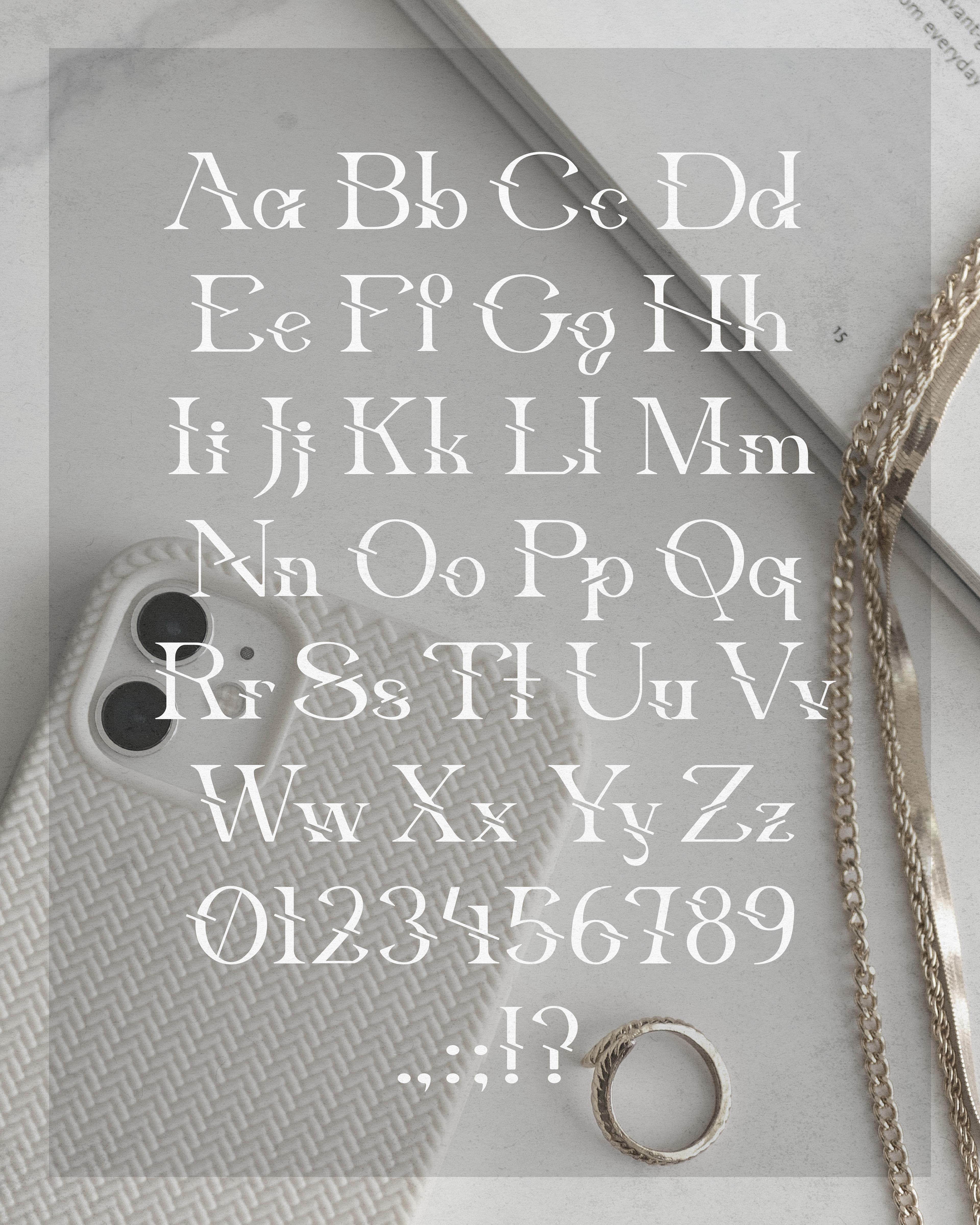 Character map of "Fractalite" font displayed over a gold jewelry background, designed by Jorda Thomas.