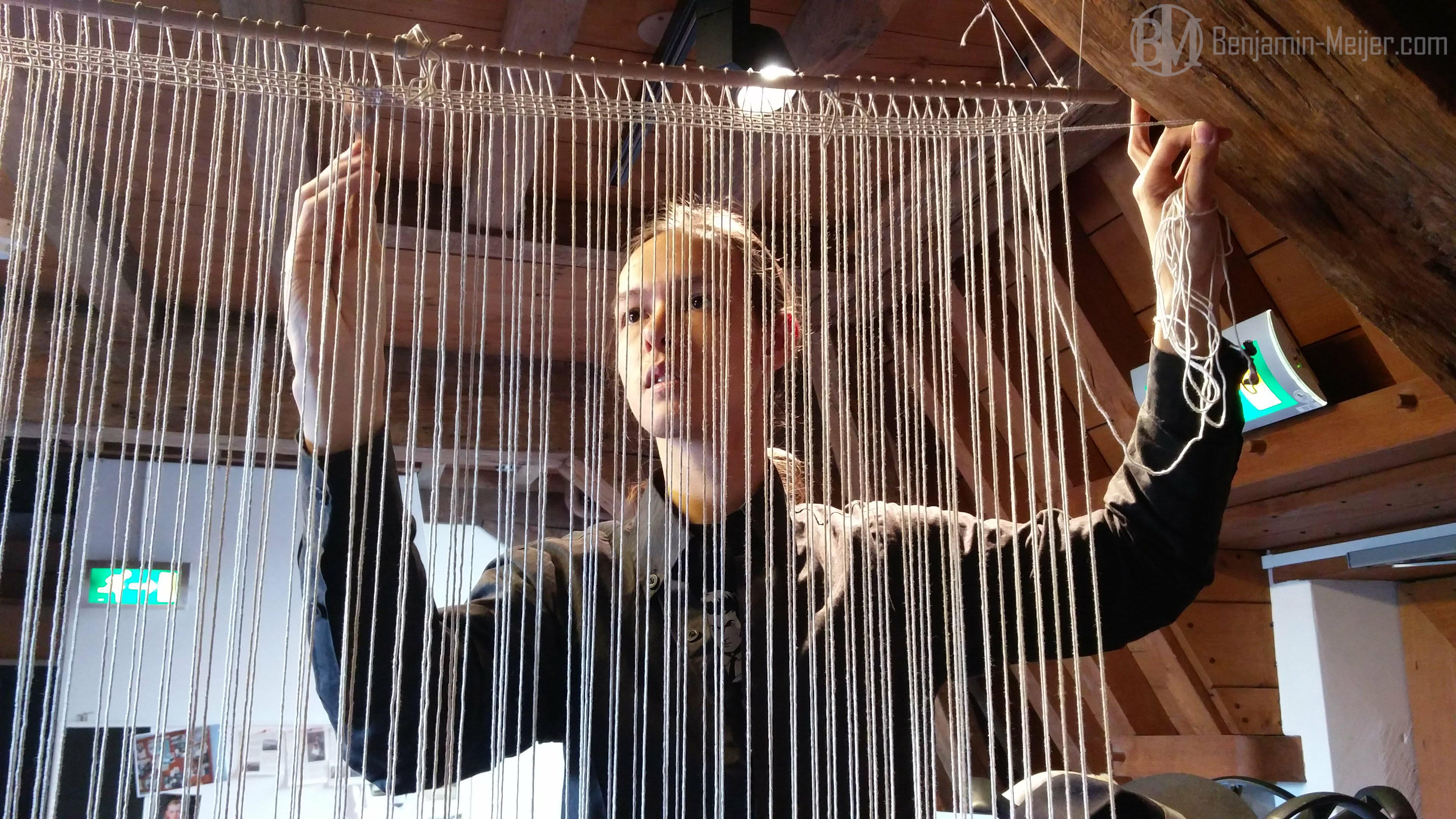 Weaving the threads for the loom, in the middle of an office
