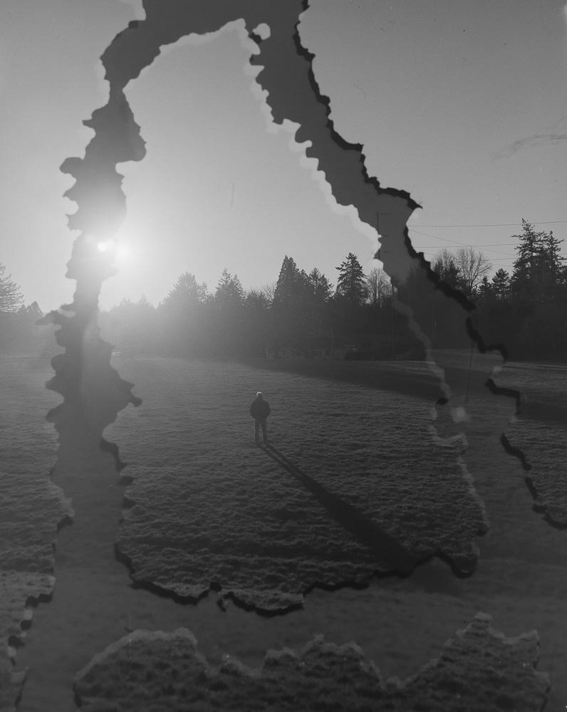 Mike Kortenhoff stands at Bridlemile school where a 2020 US geological survey revealed a fault line called the Sylvan-Oatfield fault lies just beneath. Many fault lines like this span across the Portland metro area, but none pose as much of a threat as the Cascadia Subduction Zone. This image was taken in camera using controlled double exposures on 4x5 film without the use of post-process digital manipulation. 