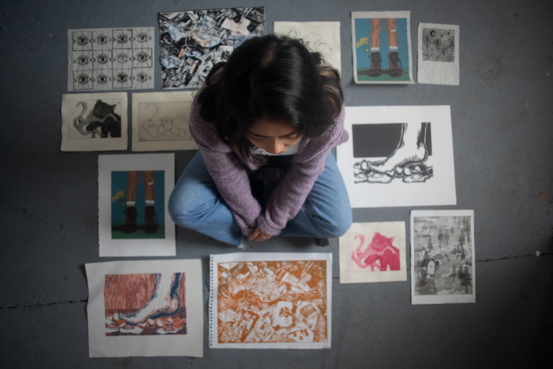 McCall sits amongst various prints she’s made over the past two years. McCall began to explore her Attention-Deficit Hyperactivity Disorder in some of her prints after she was diagnosed at the age of 21. Some of her work features amalgamations of objects that represent the different ADHD symptoms that she experiences. “I wanted to depict objects that I considered to be a part of my everyday ADHD,” McCall says.