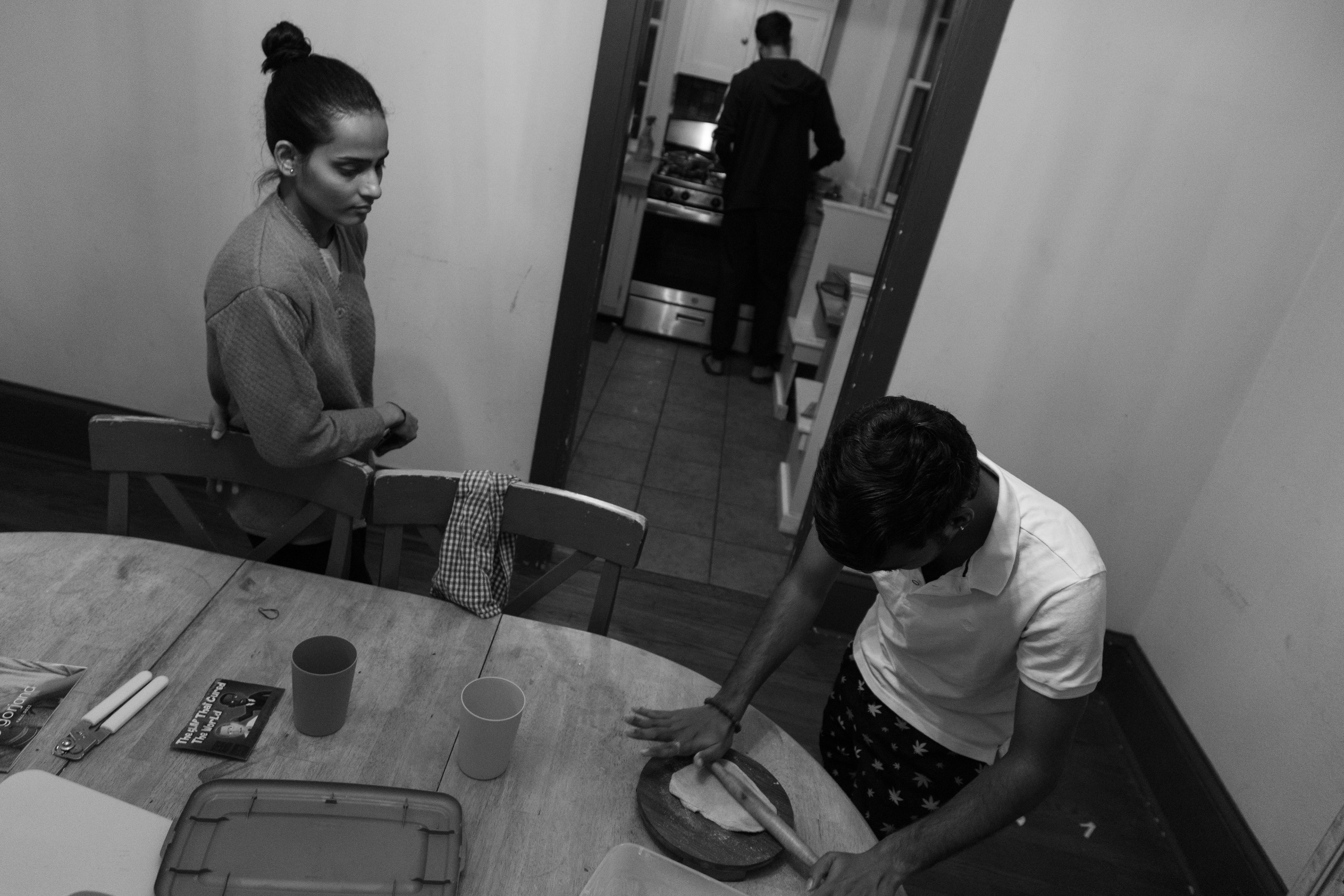 From left, Priyanka Bugde, Shantanu Ghar and Dhananjaya Rao Sirasati prepare for dinner. They make up three of five rommates who live in the home. All of the roommates are international students from Mumbai, India, and cook together every night.