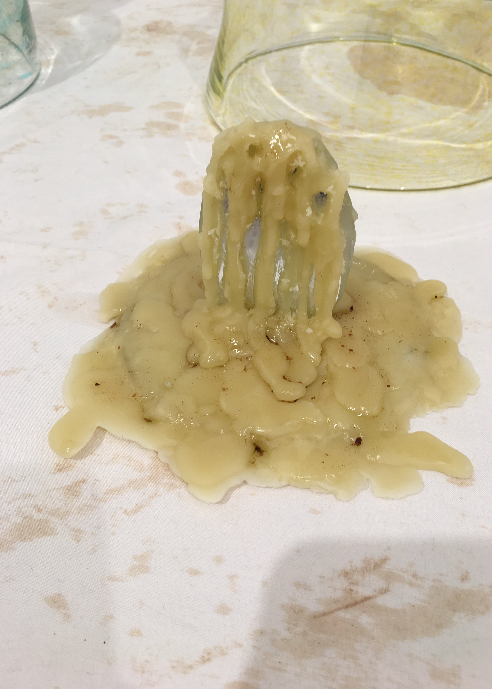 Summer: an oval mirror, dripped in a pool of melted wax