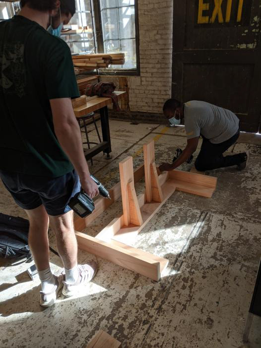Our build team assembling our bench design. Braiden Beam, who oversaw the woodworking is pictured to the left.