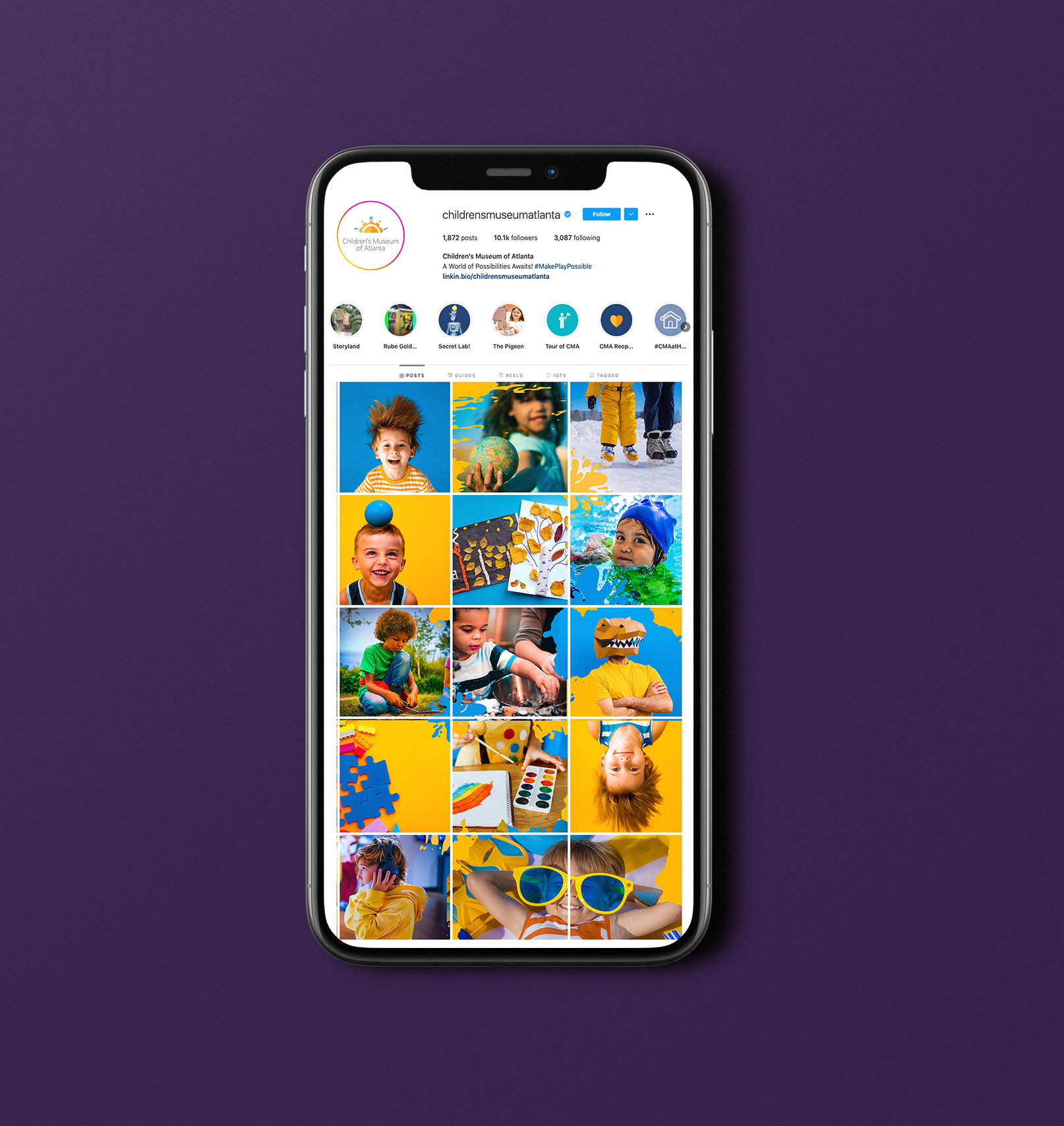 Mockup of a phone showing an instagram feed designed for a children's museum in a puzzle style grid using yellow and blue colors.