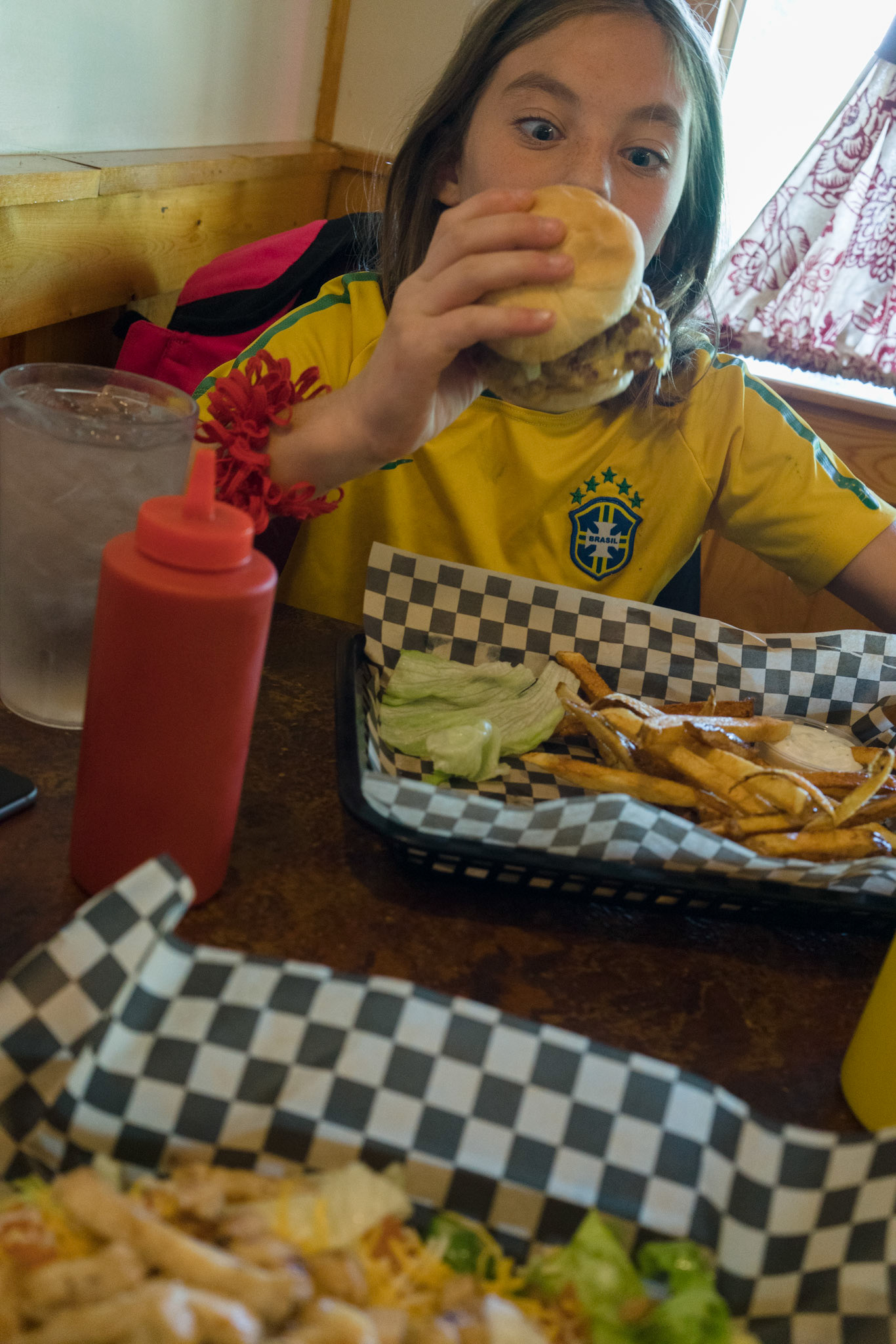 We order the usual for these parts — burger and fries — and settle into a game of Boggle then Connect 4 (our family classics) as we wait.“I beat you, I beat you!” she chides when she wins a round.She is getting into a silly mood, playing out of turn, so I sit back to write a little.“I’m writing down what you say,” I warn her.“Are you really?” She knows the answer, of course. It’s nothing new.