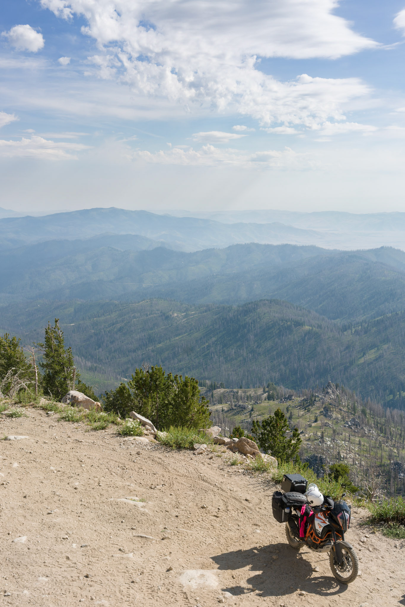 We tried five years ago, Brenna and I, to take the Jeep to Trinity Lookout¹ but the road that way is gated to anything bigger than a small ATV. We were turned back. I’m excited to finally show her the view.The first hundred yards past the gate are loose, softball-sized rocks. It’s a bit tricky. Brenna can feel us bouncing left and right as the motor growls.“I don’t like this,” she says.“It’s okay, kiddo,” I assure her. I start pointing out different sights to distract her from worry. She is relieved when finally we reach the top.___¹ Trail Image, “Big Trinity Damsels”: https://www.trailimage.com/big-trinity-damsels
