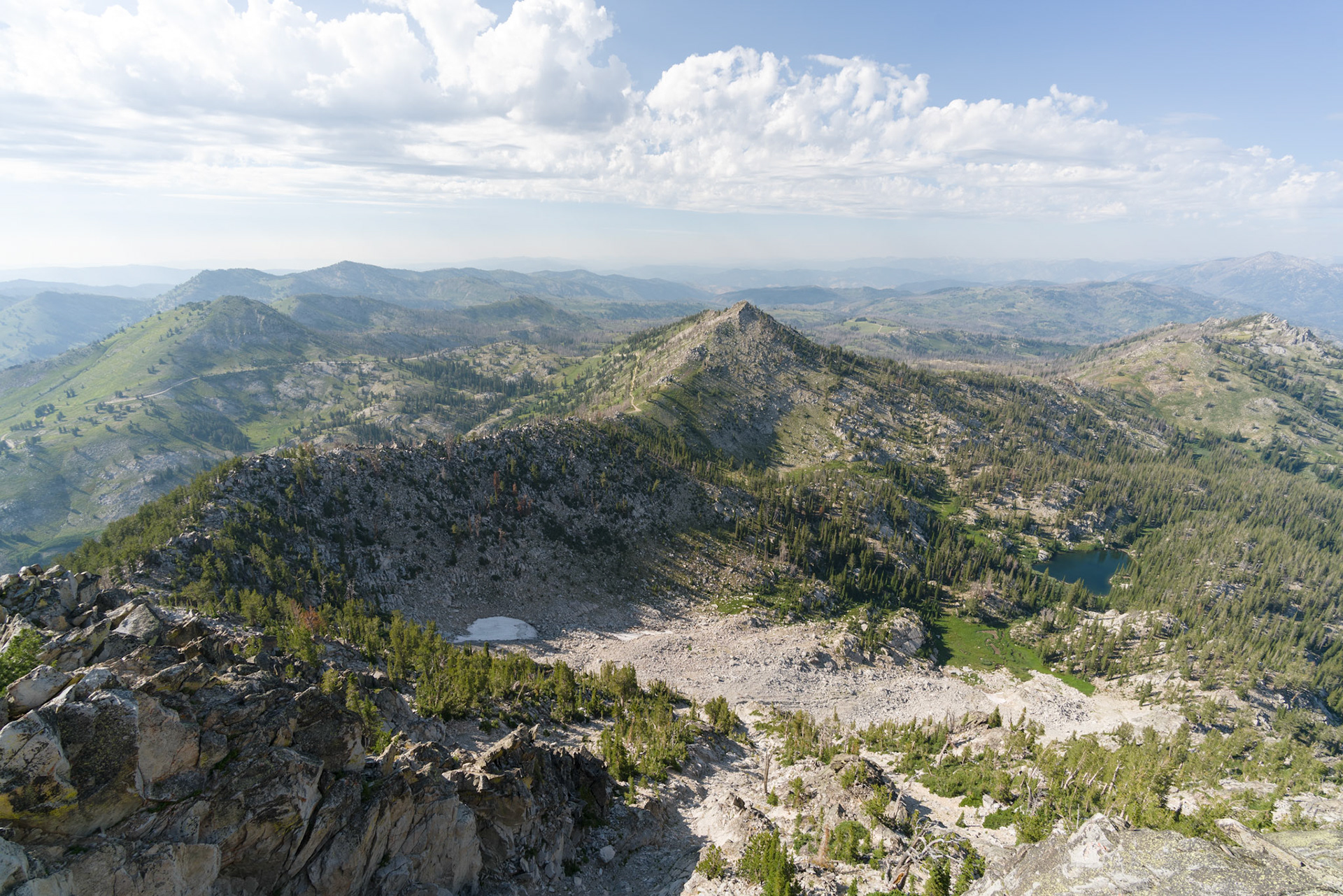 I try to cheer Brenna up with a walk around the lookout deck, peering out across mountains, endless in every direction, and in through the windows at the curious accoutrements of lookout life. (It’s the first time I’ve been here without an attendant on hand.)