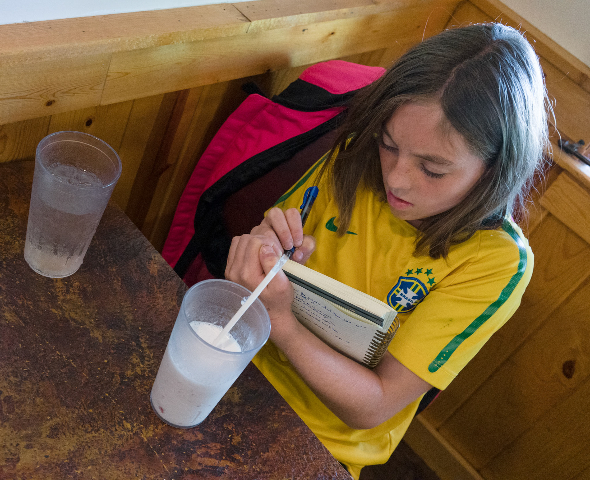 She asks see what I’ve written then takes my pen to write something of her own.