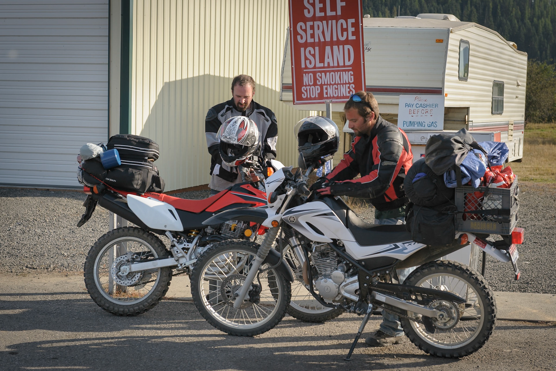 We had a route in mind that would keep us on dirt or gravel roads over Moscow Mountain to Princeton, around Gold Hill to Laird Park and on to Clarkia. But we’d all ridden much of that same route recently¹ and were eager to get straight to the higher mountains and set up camp. So we simply took the two lane highway through Troy, Deary and Bovill over to Clarkia. It follows hills and curves through tall pines—a lot of fun on my GS but not so much for my brothers, vibrating along, full in the wind at their top speeds of about 60 MPH. Poor fellas. Their tanks hold only a few gallons so we stopped for gas in Clarkia.___¹ Trail Image, “Paths Around the Palouse”: http://trailimage.blogspot.com/2008/07/paths-around-palouse.html