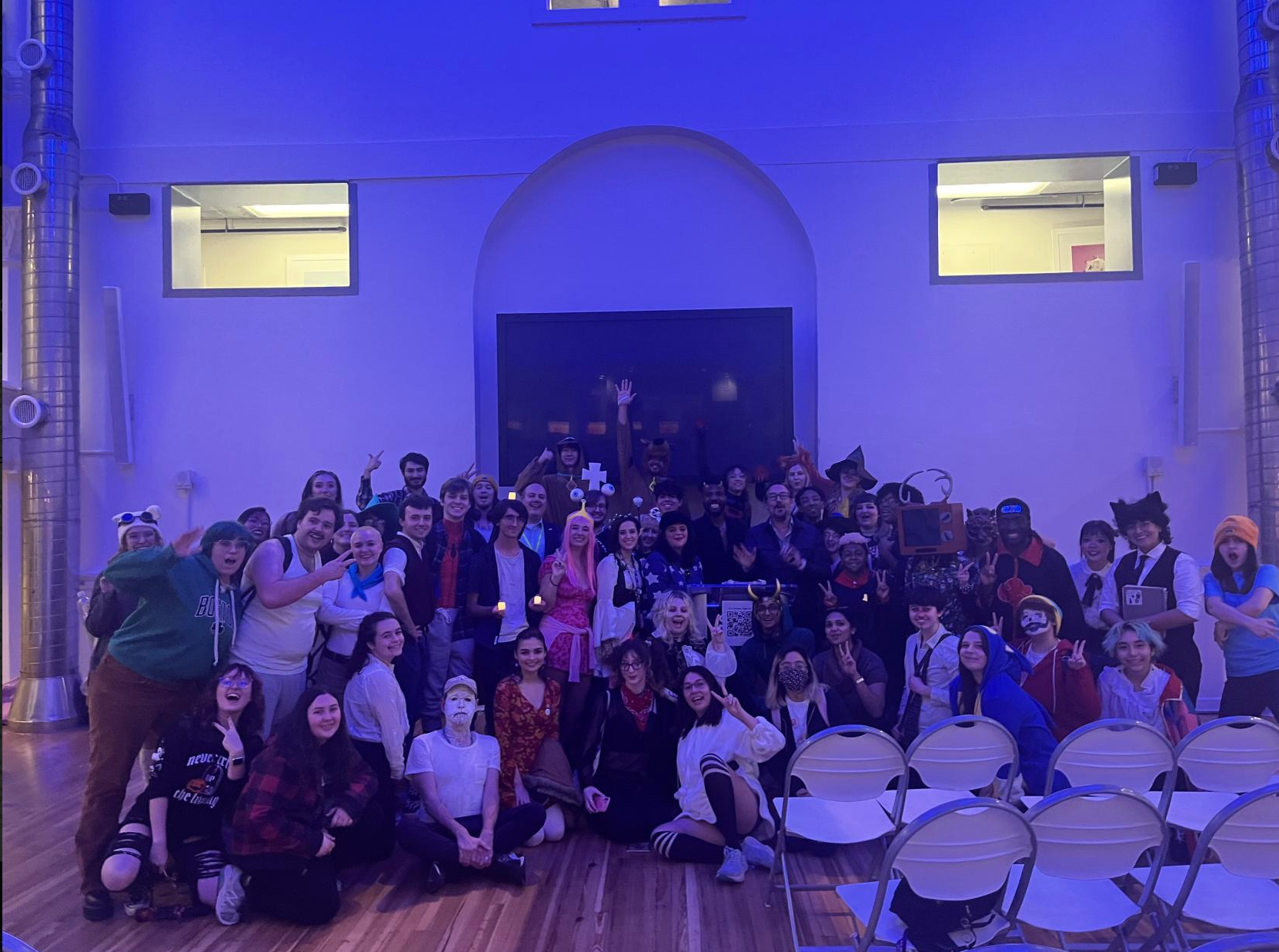 Michael Ouweleen surrounded by 2DX officers and members in Halloween costumes