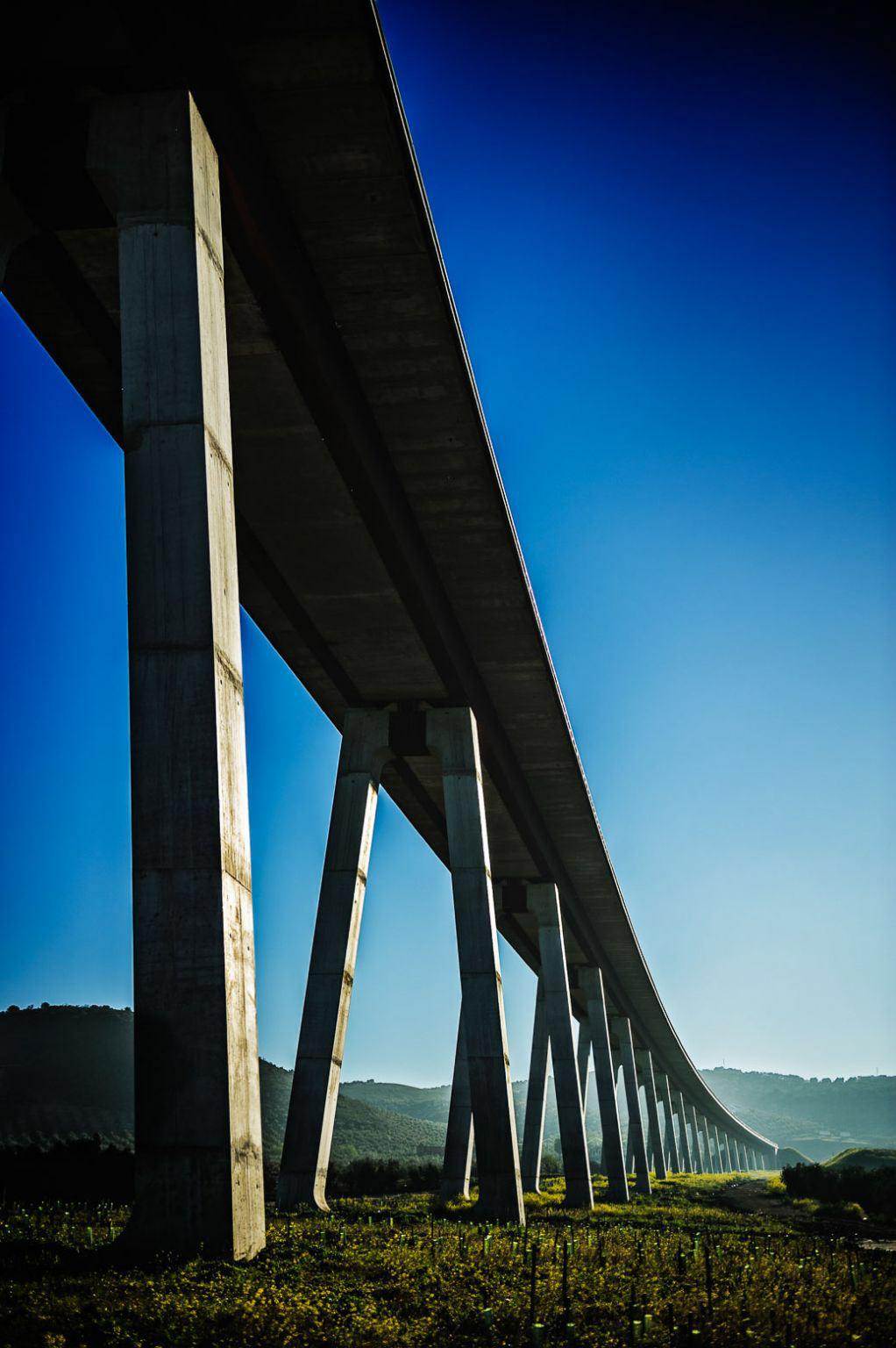 High-Speed Rail Viaduct. Antequera-Granada line, under construction. Archidona, Málaga, Andalucía. Experts state that an average high-speed rail (HSR) corridor between two cities can be regarded as socially beneficial when it carries around 8 million yearly passengers. In Spain, not even the HSR corridor between Madrid and Barcelona reaches that figure, so the perspectives for the line between Antequera and Granada (serving a total population of only 280,000) are rather despairing. Its budget amounts to €1.2 billion, half of which is financed by the European Union. Furthermore, Antequera will be the only city besides Madrid and Barcelona in having two HSR-stations.