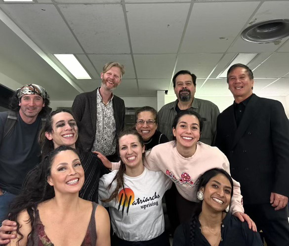 Group photo of nine people, looking at the camera