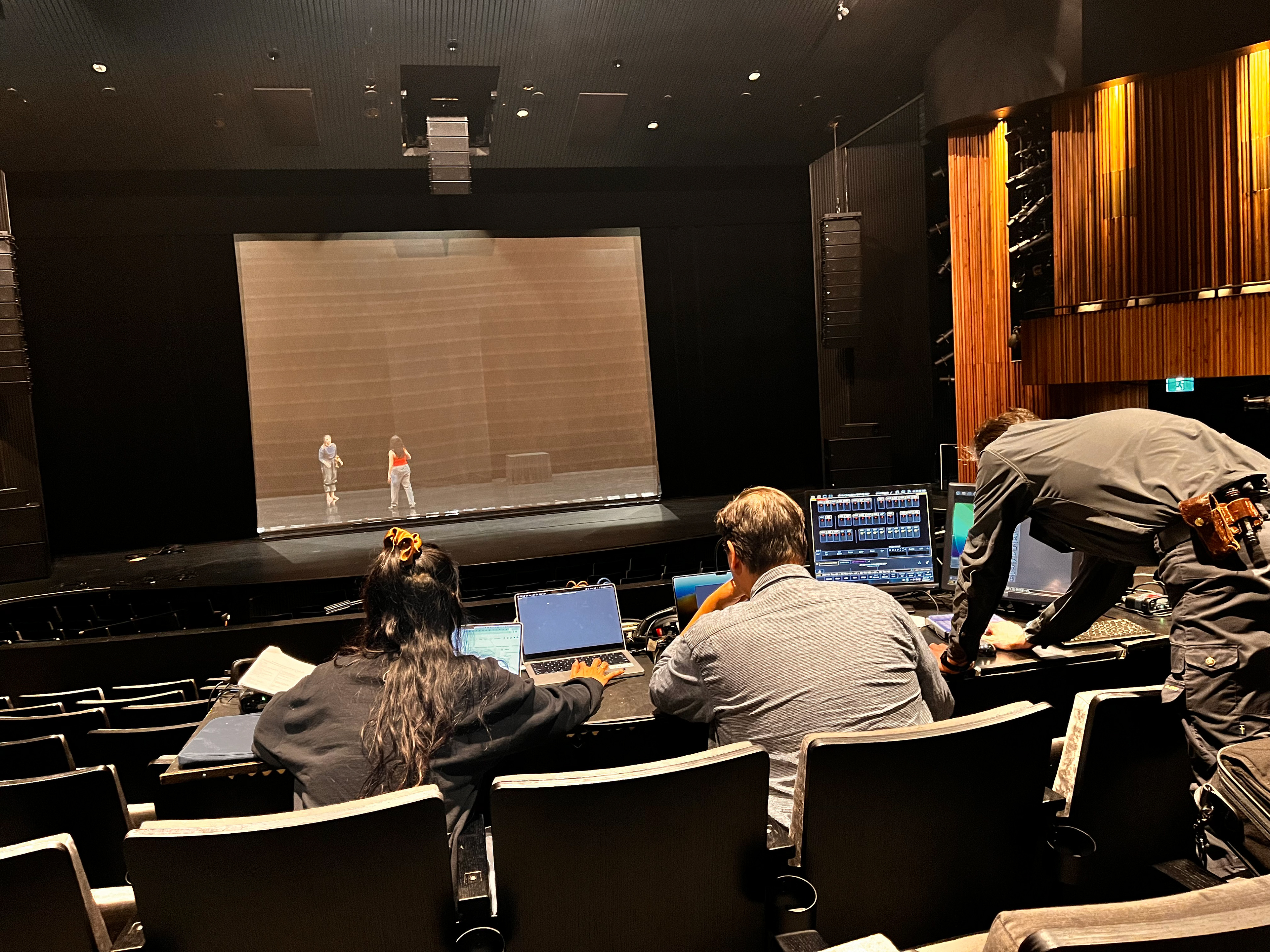 Artists working in a theatre auditorium