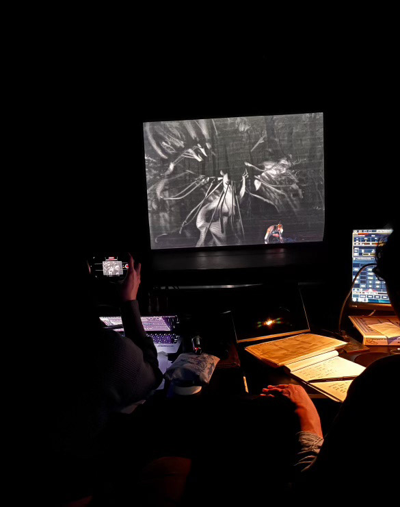 A theater stage with a video projection showing an abstract image